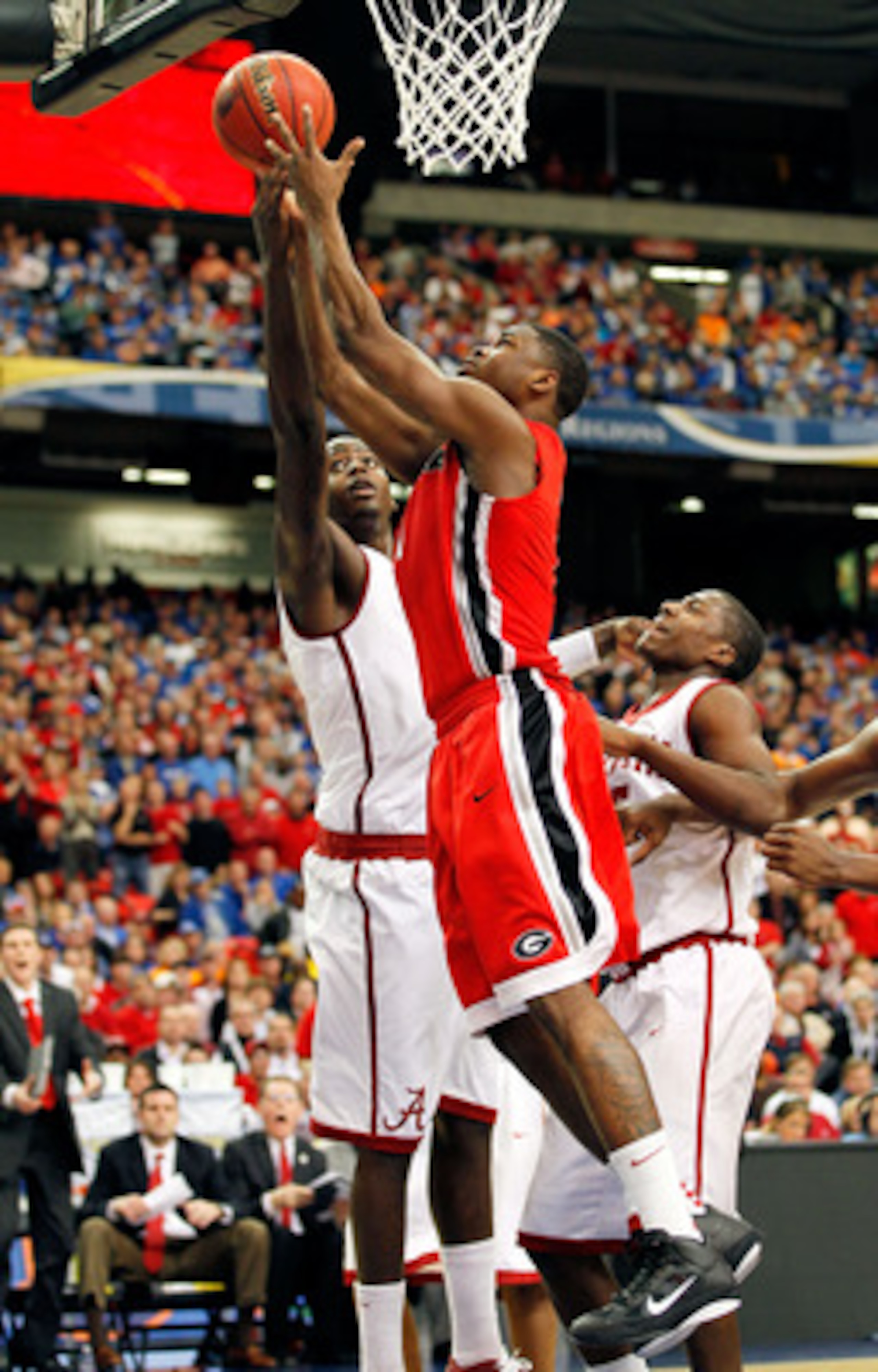 ATLANTA, GA - MARCH 11: Travis Leslie #1 of the Georgia Bulldogs and JaMychal Green #1 of the Alabama Crimson Tide vie for a rebound during the quarterfinals of the SEC Men's Basketball Tournament at Georgia Dome on March 11, 2011 in Atlanta, Georgia.  (P