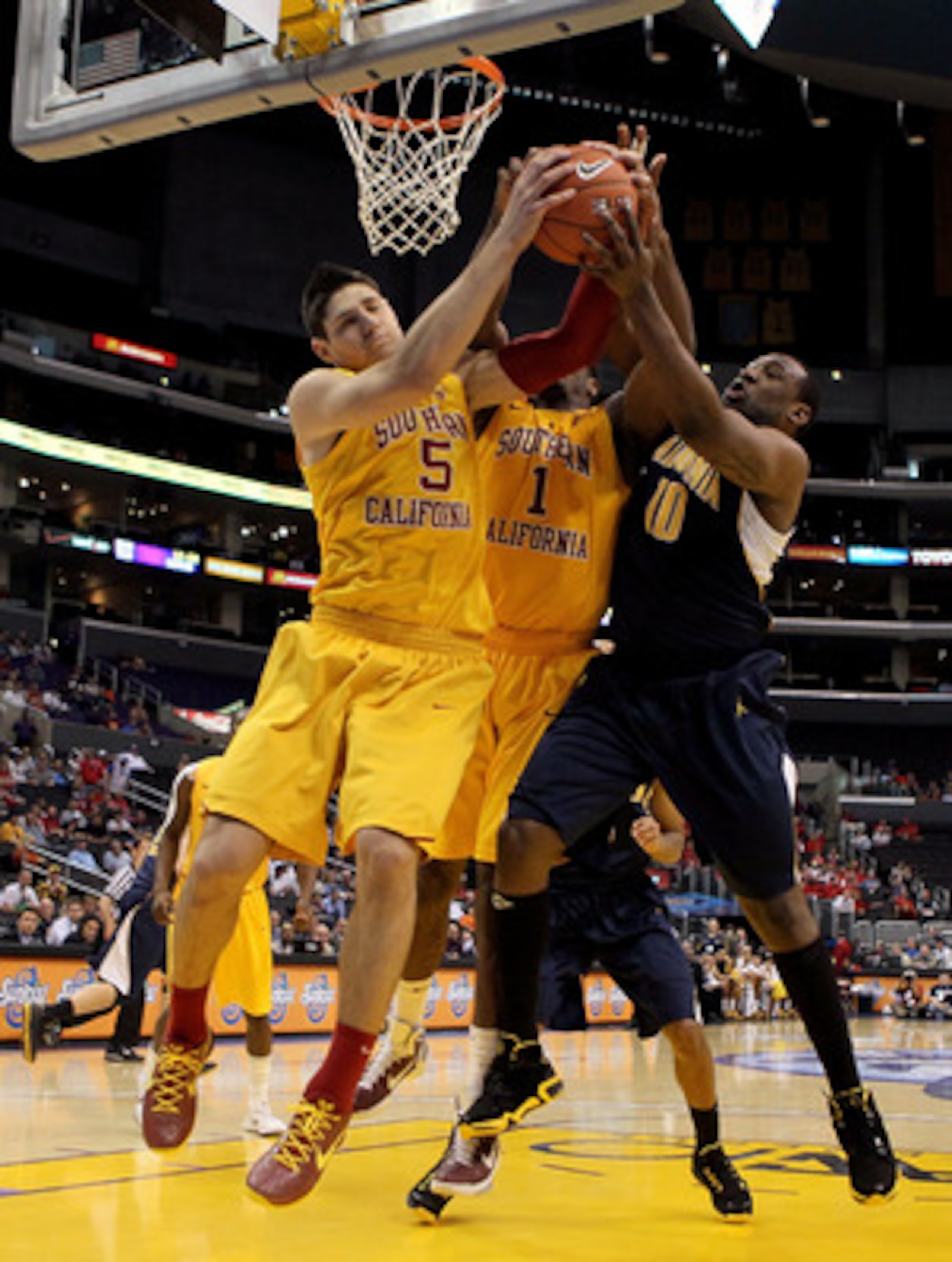 LOS ANGELES, CA - MARCH 10:  Nikola Vucevic #5 and Alex Stepheson #1 of the USC Trojans battle for a rebound with Markhuri Sanders-Frison #10 of the California Golden Bears in the second half in the quarterfinals of the 2011 Pacific Life Pac-10 Men's Bask
