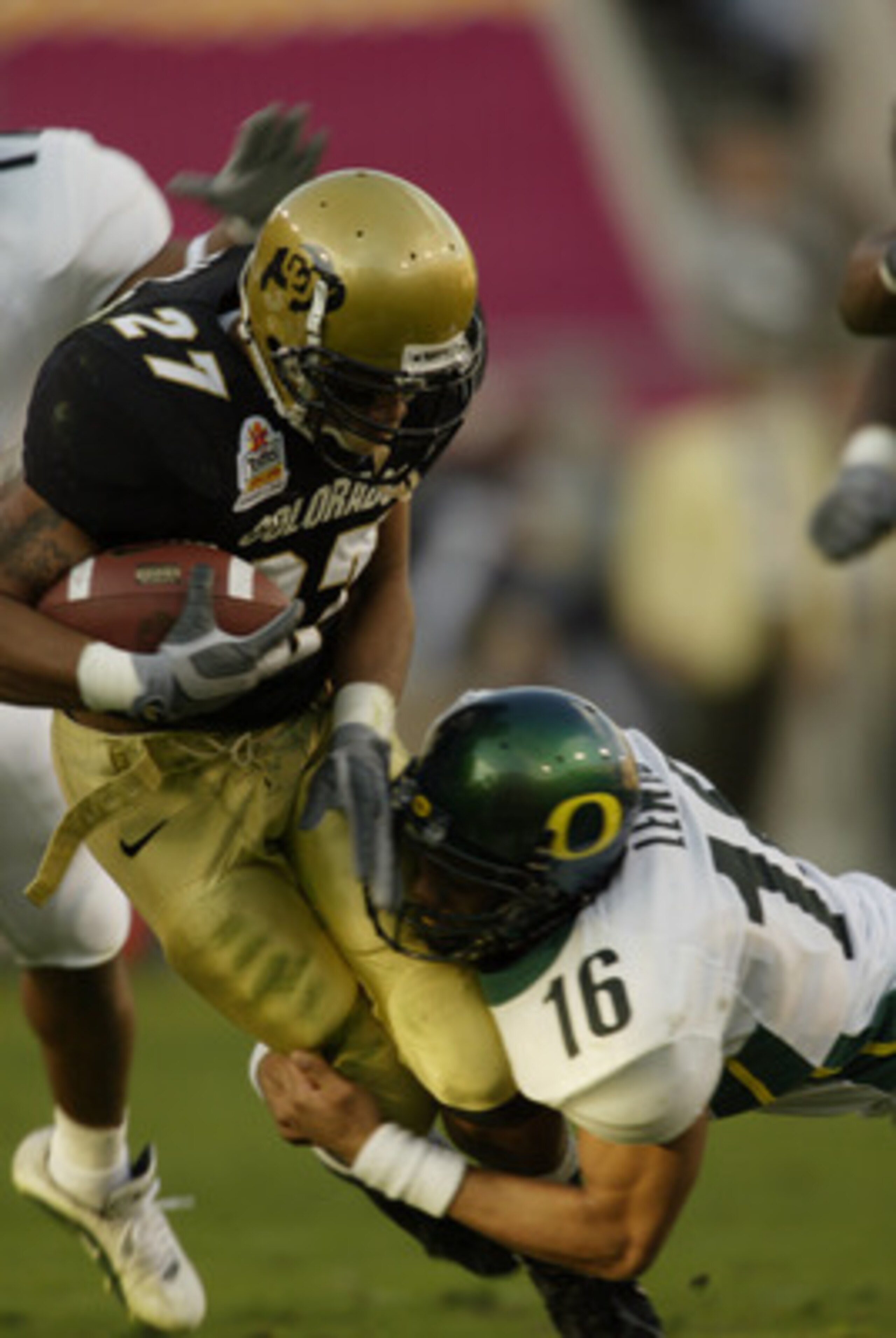 01 Jan 2002 : Cortlen Johnson #27 of Colorado is stopped by Keith Lewis #16 of Oregon during the game at the  Fiesta Bowl at Sun Devil Stadium in Tempe, Arizona. The Oregon Ducks won 38-16. DIGITAL IMAGE. Mandatory Credit: Brian Bahr/Getty Images