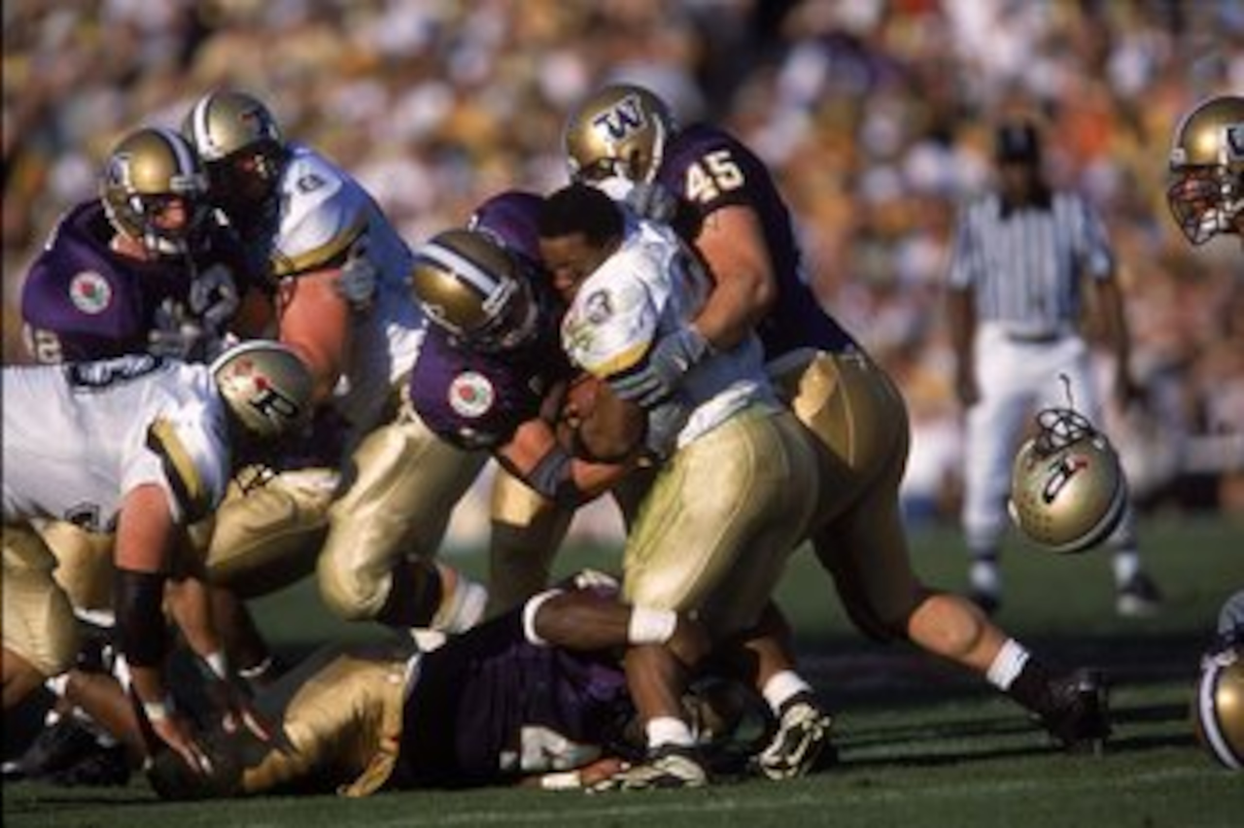 1 Jan 2001:  Montrell Lowe #3 of the Purdue Boilermakers looses his helemt against Spencer Marona #45 and Greg Carothers #34 of the Washington Huskies during the Rose Bowl Game at the Rose Bowl in Pasadena, California. The Huskies defeated the Boilermaker