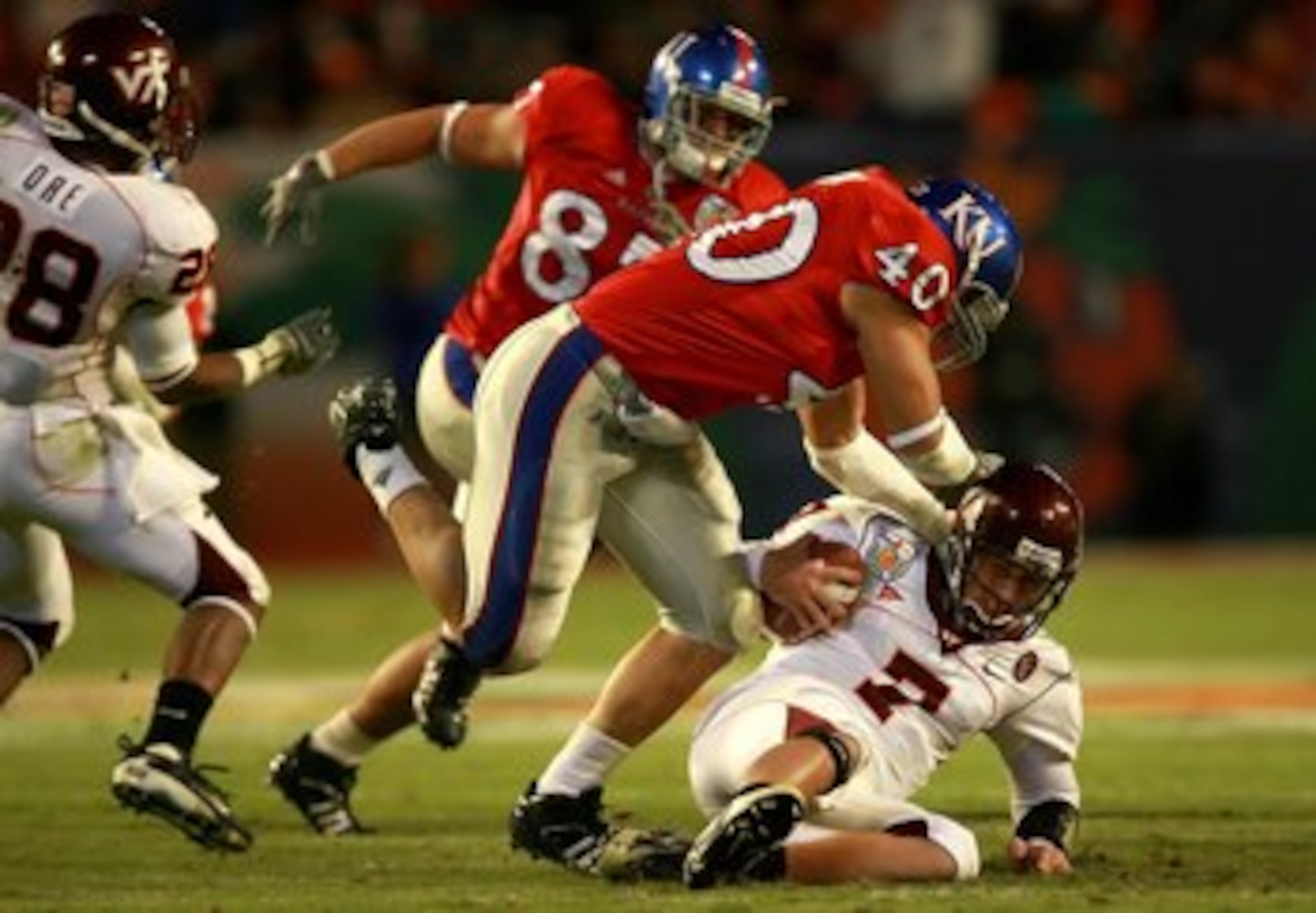 MIAMI - JANUARY 03:  Quarterback Sean Glennon #7 of the Virginia Tech Hokies is sacked in the fourth quarter by linebacker Mike Rivera #40 of the Kansas Jayhawks in the FedEx Orange Bowl at Dolphin Stadium on January 3, 2008 in Miami, Florida. Kansas defe