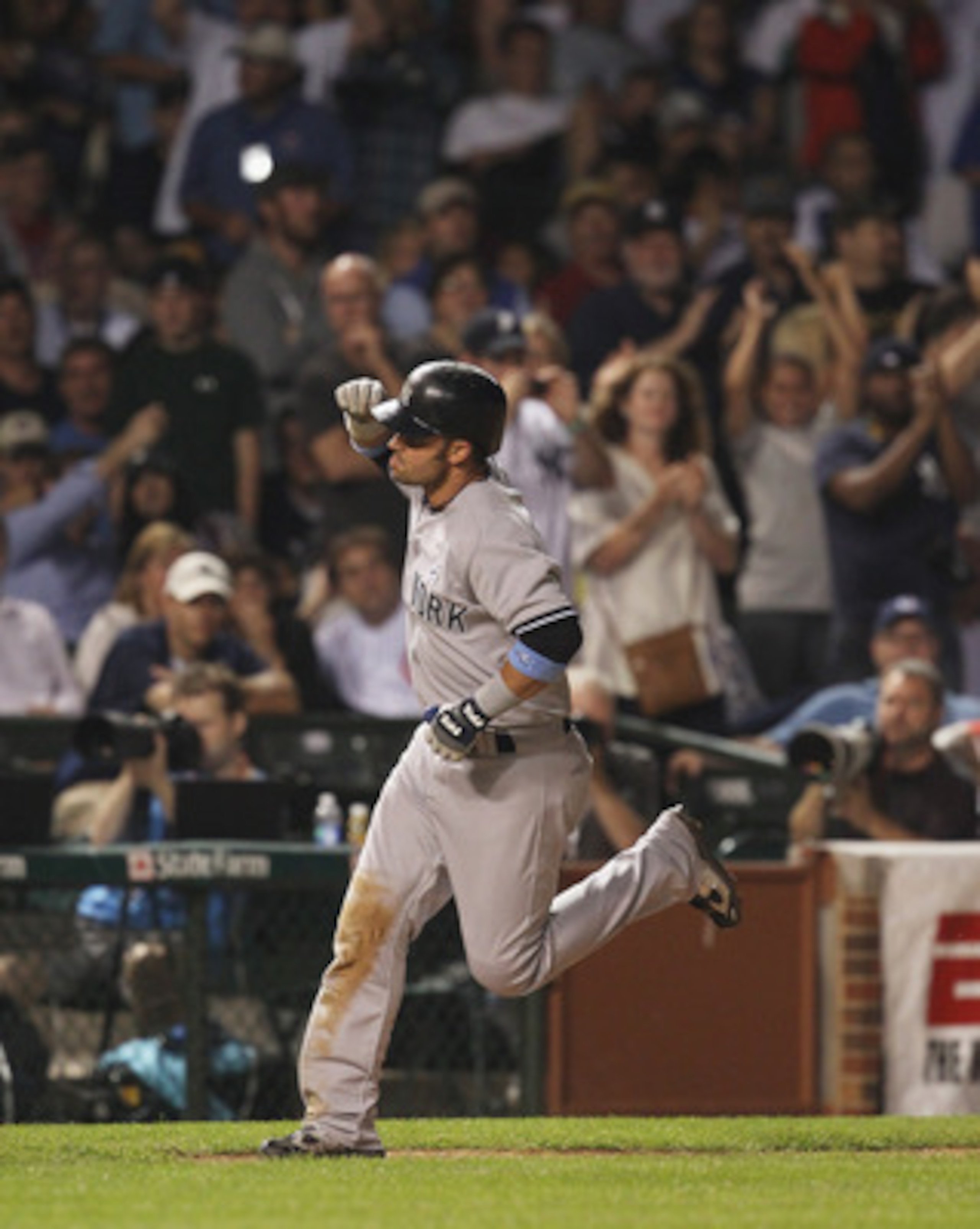CHICAGO, IL - JUNE 19:  Nick Swisher #33 of the New York Yankees celebrates his three-run home run in the 8th inning as he runs the bases against the Chicago Cubs at Wrigley Field on June 19, 2011 in Chicago, Illinois.  (Photo by Jonathan Daniel/Getty Ima