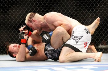 MONTREAL- MAY 8: Jonathan Goulet (top) punches Marcus Davis in their welterweight bout at UFC 113 at Bell Centre on May 8, 2010 in Montreal, Quebec, Canada.  (Photo by Richard Wolowicz/Getty Images)
