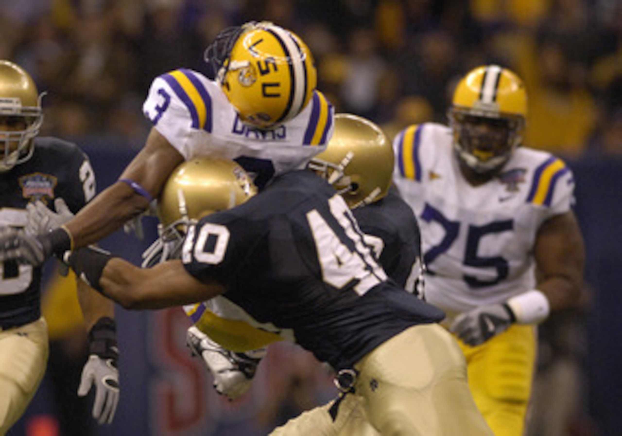 LSU Tigers Wide Receiver  # 3 Craig Davis going up over the top  against Notre Dame Fighting Irish defender linebacke  # 40 Maurice Crum Jr. tries to stop him during the AllState Sugar Bowl match  Notre Dame vs LSU on  January 3, 2007 at Superdome , New O