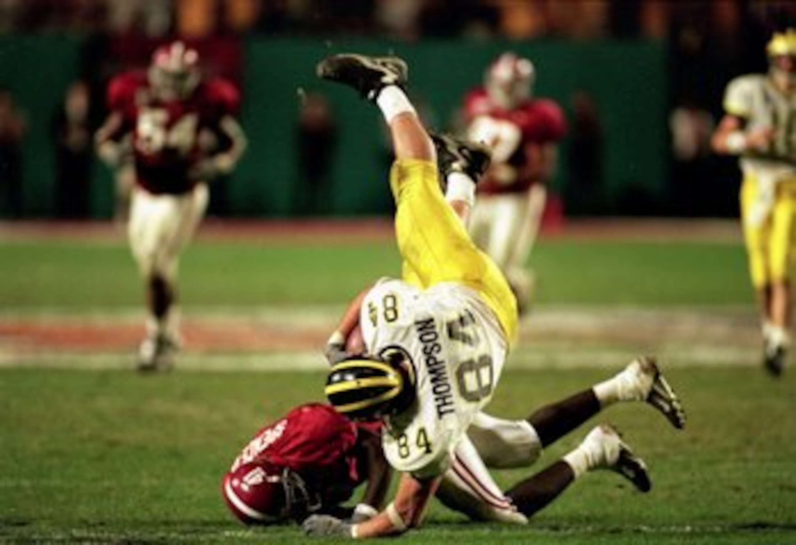 1 Jan 2000:  Shawn Thompson #84 of the Michigan Wolverines trips with the ball over another player during the Orange Bowl Game against the Alabama Crimson Tide at the Pro Player Stadium in Miami, Florida. The Wolverines defeated the Crimson Tide 35-34. Ma