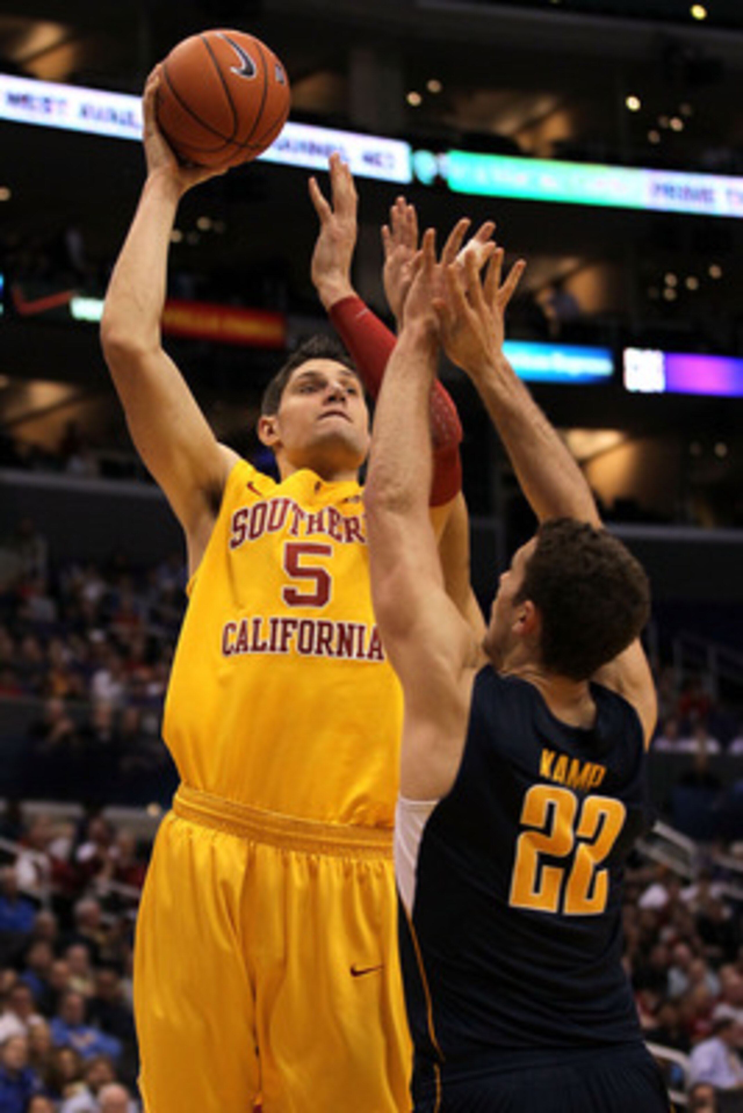 LOS ANGELES, CA - MARCH 10:  Nikola Vucevic #5 of the USC Trojans shoots over Harper Kamp #22 of the California Golden Bears in the second half in the quarterfinals of the 2011 Pacific Life Pac-10 Men's Basketball Tournament at Staples Center on March 10,