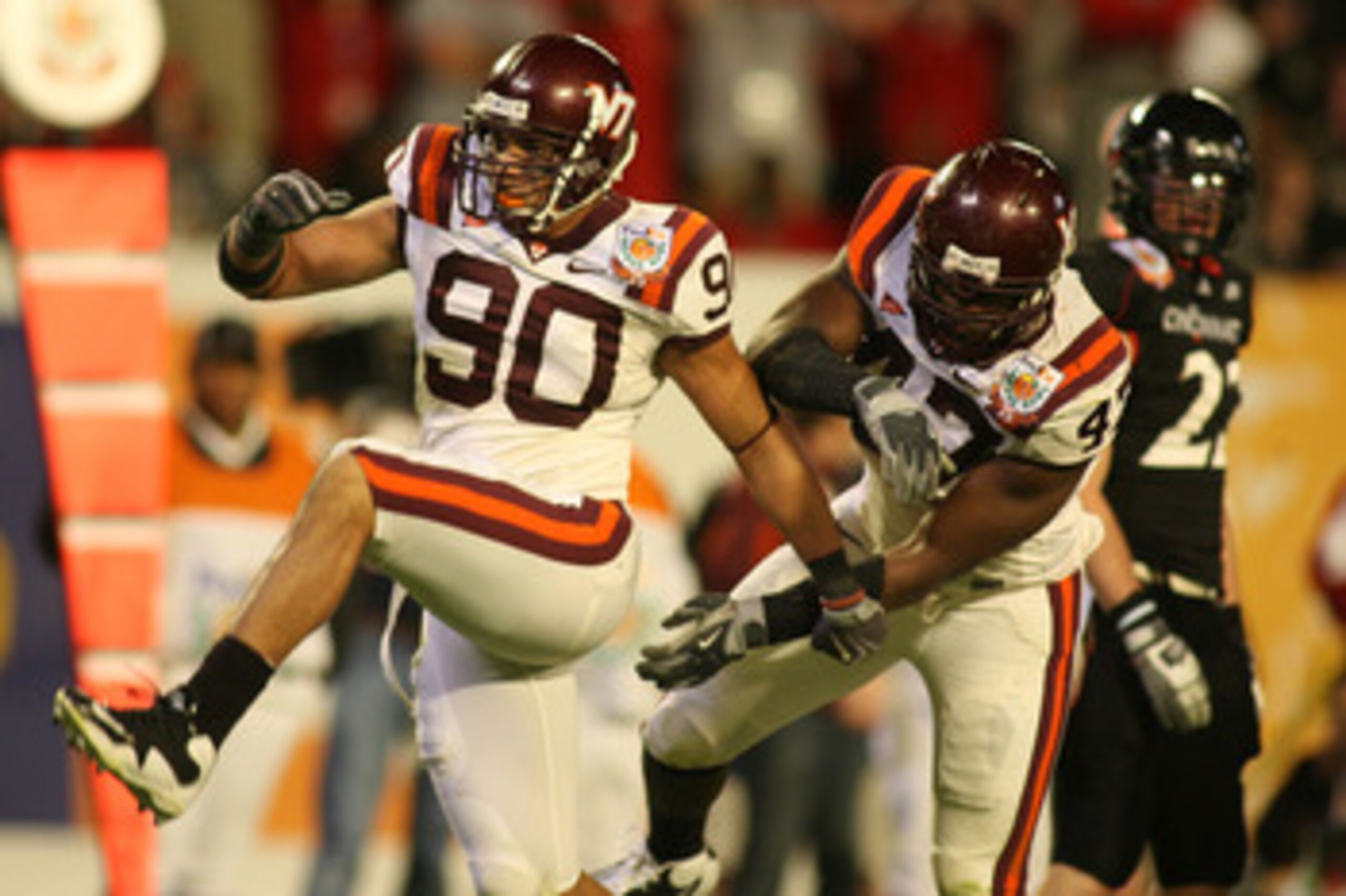 MIAMI - JANUARY 01:  Virginia Tech Hokies Orion Martin #90 celebrates his interception against the Cincinnati Bearcats with Nekos Brown #47 during the FedEx Orange Bowl at Dolphin Stadium on January 1, 2009 in Miami, Florida.  (Photo by Marc Serota/Getty