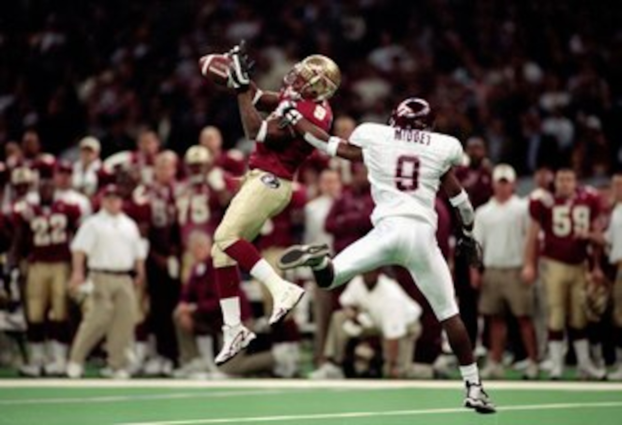 5 Jan 2000:  Peter Warrick #9 of the Florida State Seminoles jumps and catches the ball as Anthony Midget #9 of the Virginia Tech Hokies gaurds him during the Nokita Sugar Bowl Game at the Louisiana Superdome in New Orleans, Louisiana. The Seminoles defea