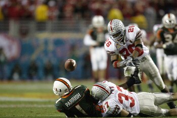 TEMPE, AZ - JANUARY 3:  Receiver Roscoe Parrish #1 of the Miami Hurricanes fumbles the football after being hit by Dustin Fox #37 of the Ohio State Buckeyes during the Tostitos Fiesta Bowl on January 3, 2003 at Sun Devil Stadium in Tempe, Arizona.  Saftey
