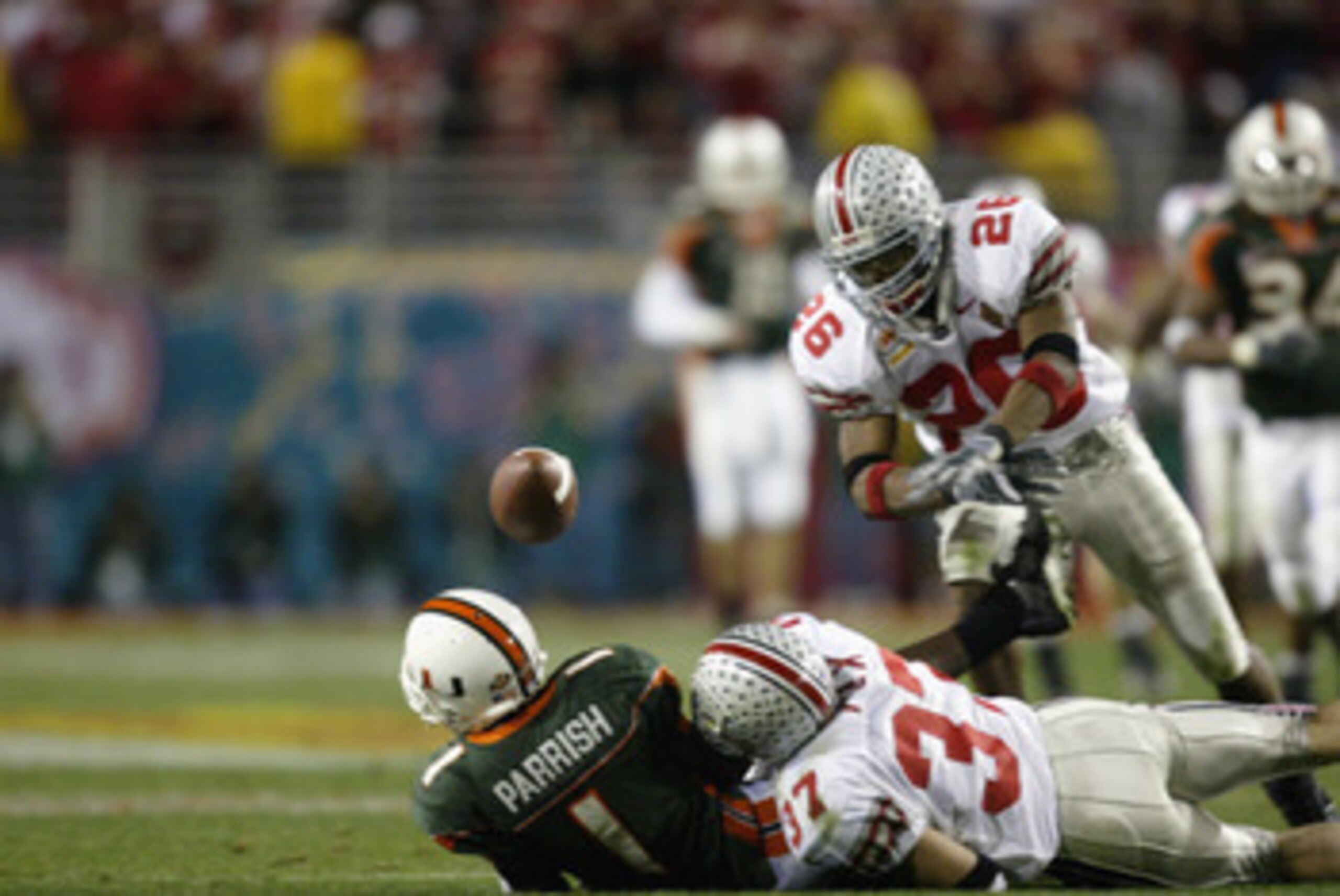 TEMPE, AZ - JANUARY 3:  Receiver Roscoe Parrish #1 of the Miami Hurricanes fumbles the football after being hit by Dustin Fox #37 of the Ohio State Buckeyes during the Tostitos Fiesta Bowl on January 3, 2003 at Sun Devil Stadium in Tempe, Arizona.  Saftey