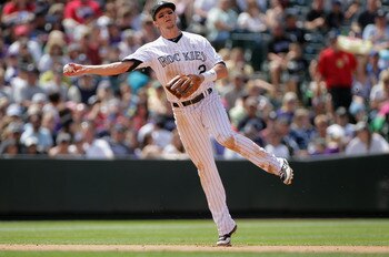 DENVER, CO - JUNE 19:  Shortstop Troy Tulowitzki #2 of the Colorado Rockies fields a gound ball and throws out the runner against the Detroit Tigers at Coors Field on June 19, 2011 in Denver, Colorado. The Tigers defeated the Rockies 9-1.  (Photo by Doug 