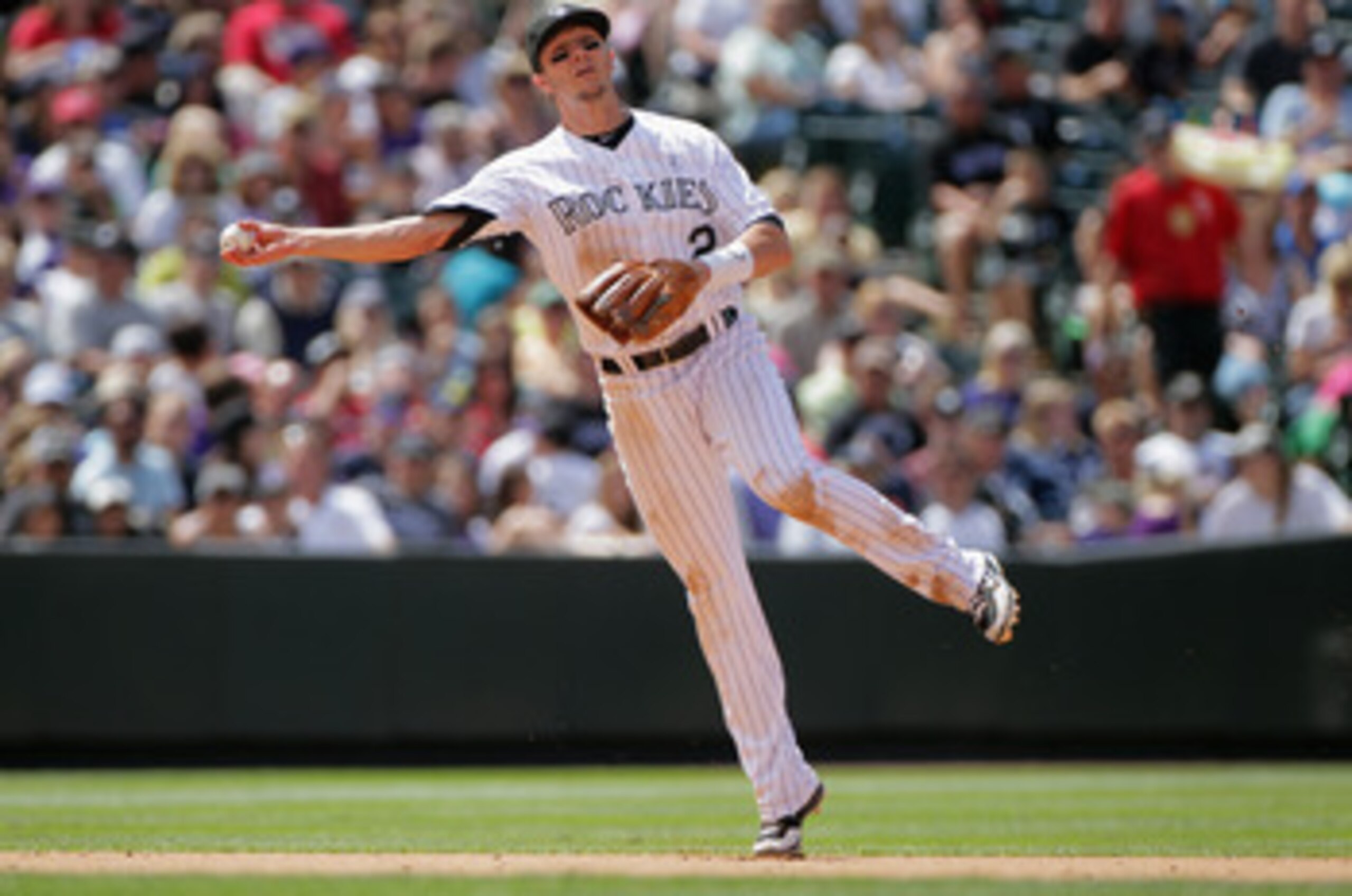 DENVER, CO - JUNE 19:  Shortstop Troy Tulowitzki #2 of the Colorado Rockies fields a gound ball and throws out the runner against the Detroit Tigers at Coors Field on June 19, 2011 in Denver, Colorado. The Tigers defeated the Rockies 9-1.  (Photo by Doug 
