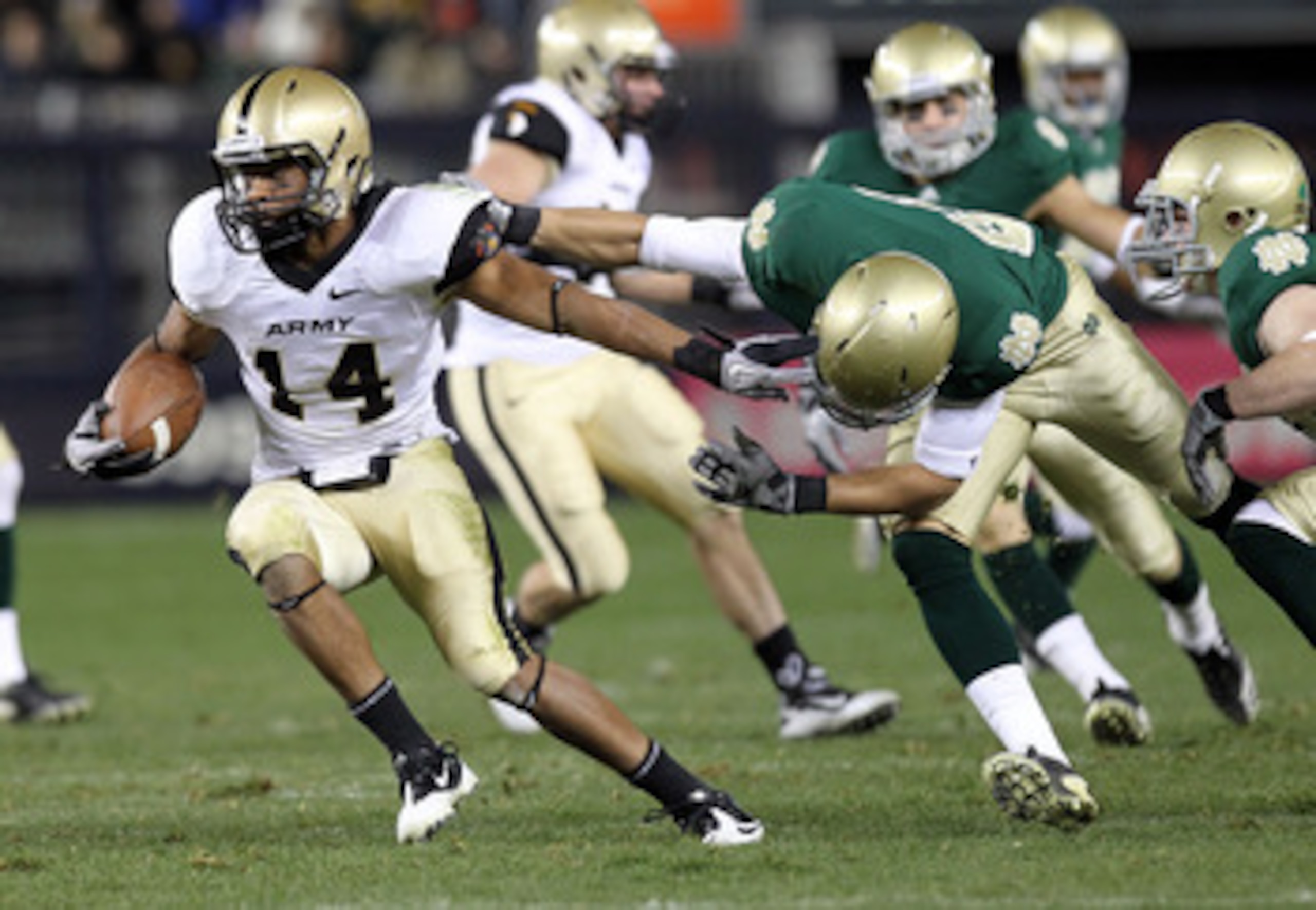 NEW YORK - NOVEMBER 20:  Josh Jackson #14 of the Army Black Knights is tackled on a kickoff return by the Notre Dame Fighting Irish at Yankee Stadium on November 20, 2010 in the Bronx borough of New York City.  (Photo by Nick Laham/Getty Images)
