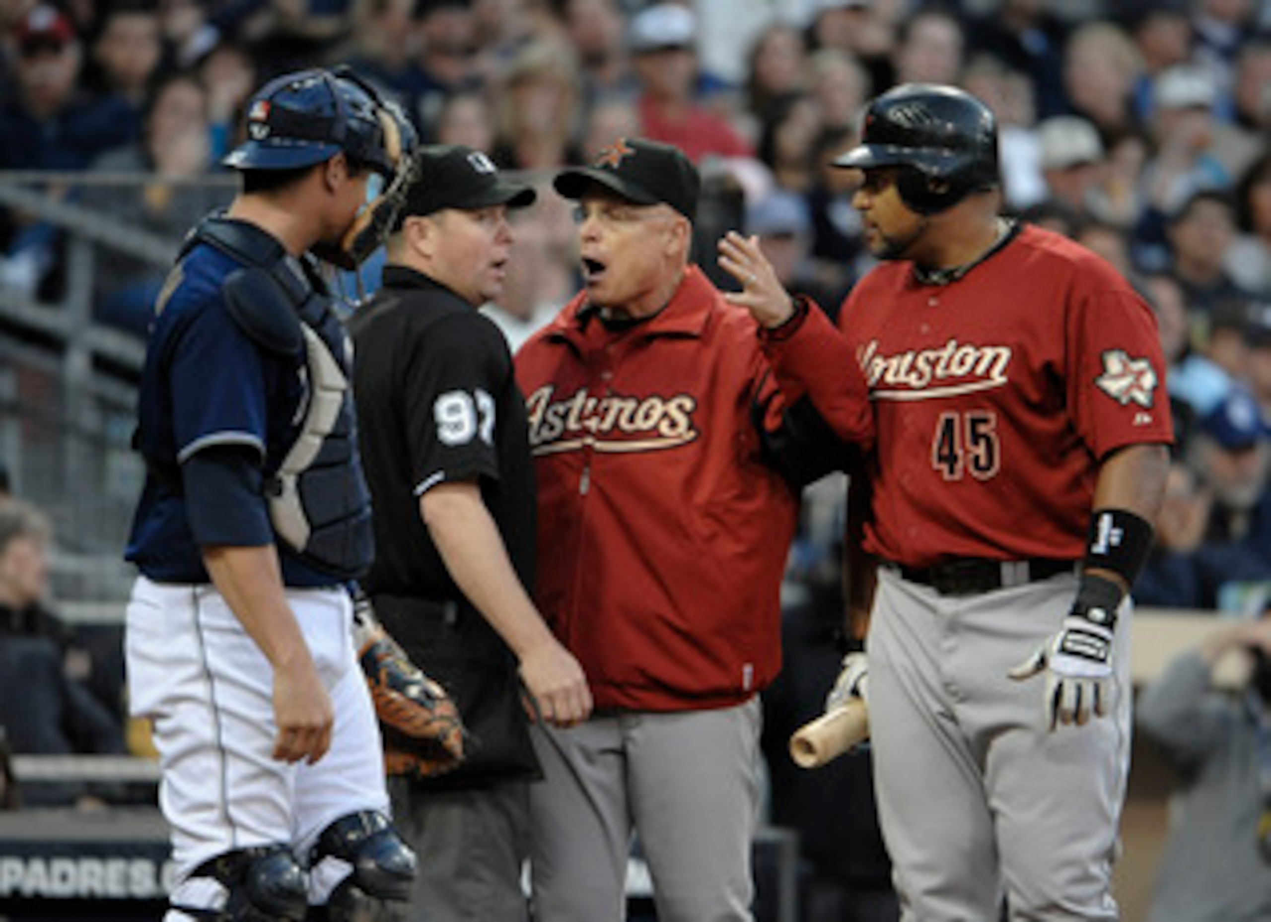 SAN DIEGO, CA - JUNE 4: Manager Brad Mills and Carlos Lee #45 of the Houston Astros argue a call with umpire Todd Tichenor as Rob Johnson #32 of the San Diego Padres looks on during the eighth inning of a baseball game at Petco Park on June 4, 2011 in San