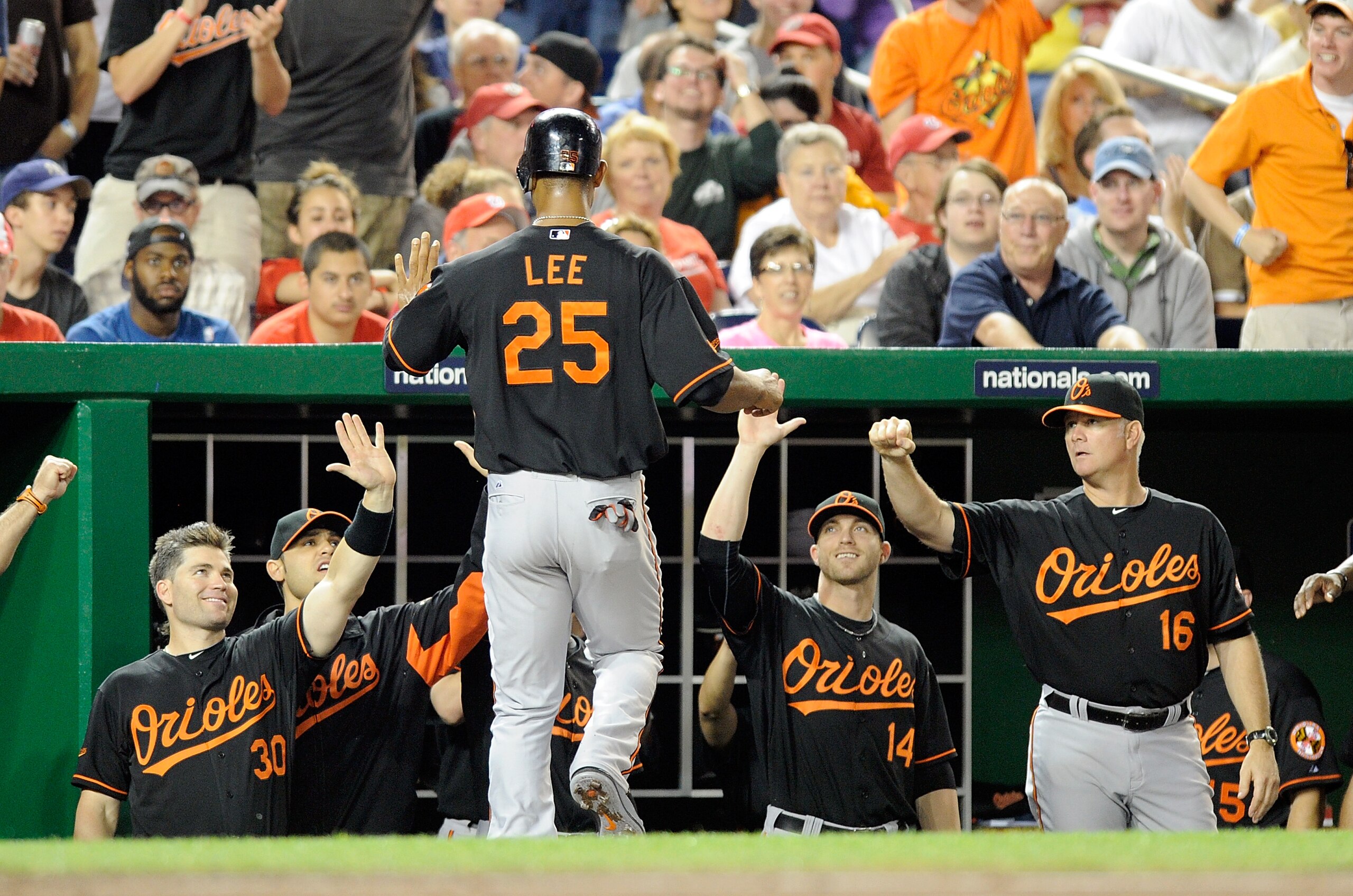 WASHINGTON, DC - JUNE 17:  Derrek Lee #25 of the Baltimore Orioles is congratulated by teammates after scoring in the fourth inning against the Washington Nationals at Nationals Park on June 17, 2011 in Washington, DC.  (Photo by Greg Fiume/Getty Images)