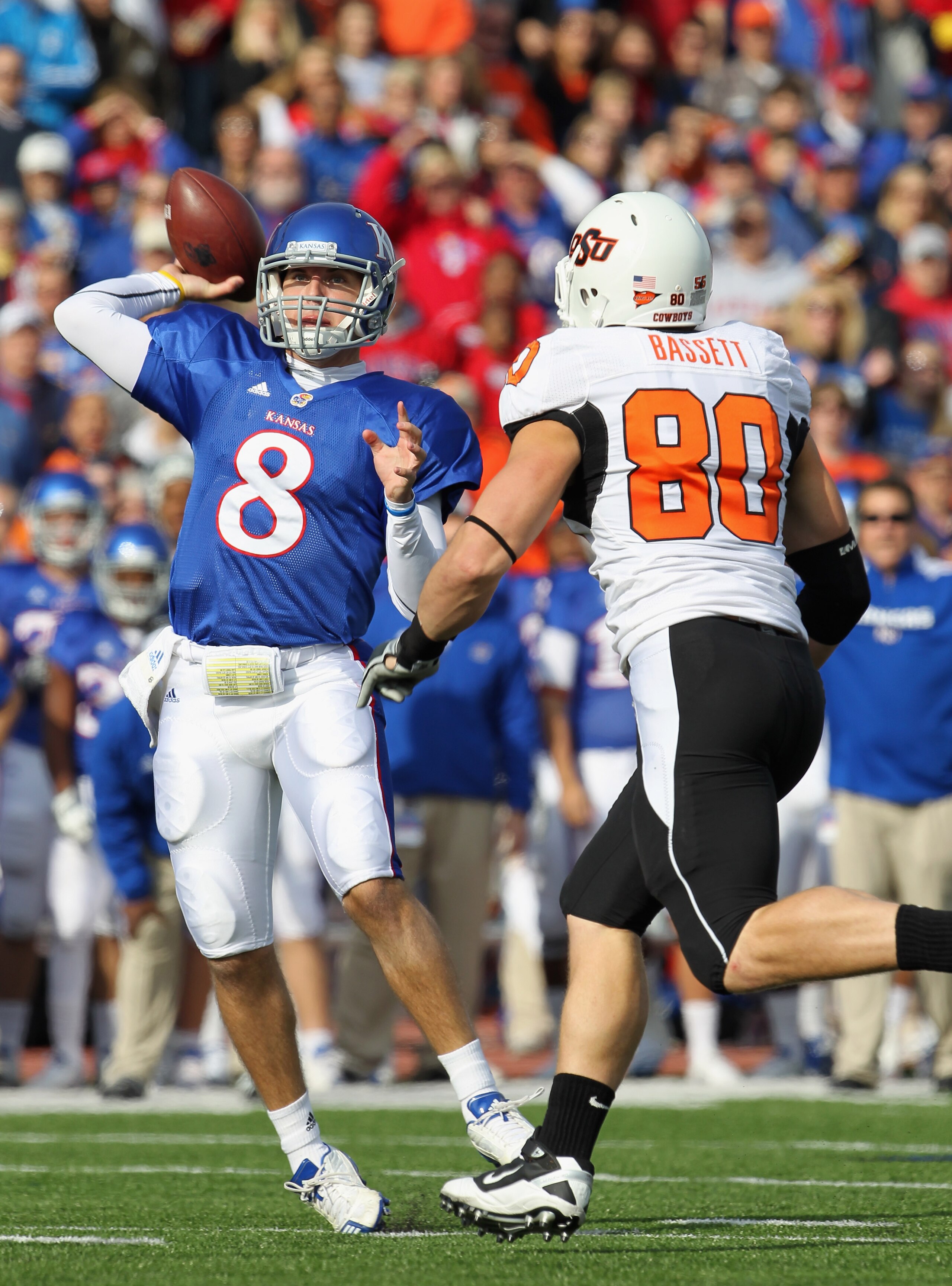 LAWRENCE, KS - NOVEMBER 20:  Quarterback Quinn Mecham #8 of the Kansas Jayhawks passes as Cooper Baskett #80 chases during the game on November 20, 2010 at Memorial Stadium in Lawrence, Kansas.  (Photo by Jamie Squire/Getty Images)