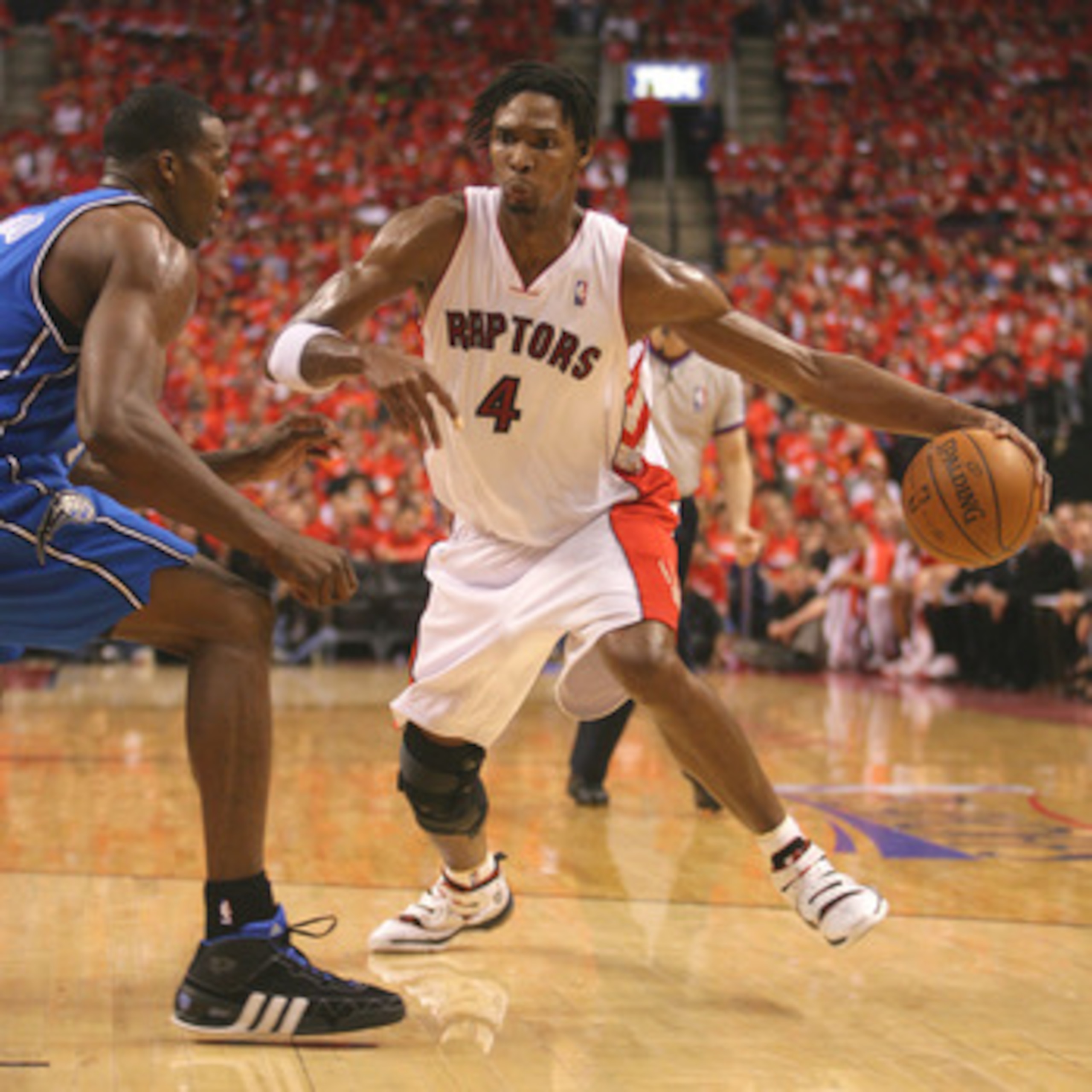 TORONTO,ON - APRIL 24: Chris Bosh #4 of the Toronto Raptors goes around Dwight Howard #12 of the Orlando Magic in game 3 of the Eastern Conference quarterfinals on April 24, 2008 at the Air Canada Centre in Toronto, Ontario. (Photo by Claus Andersen/Getty