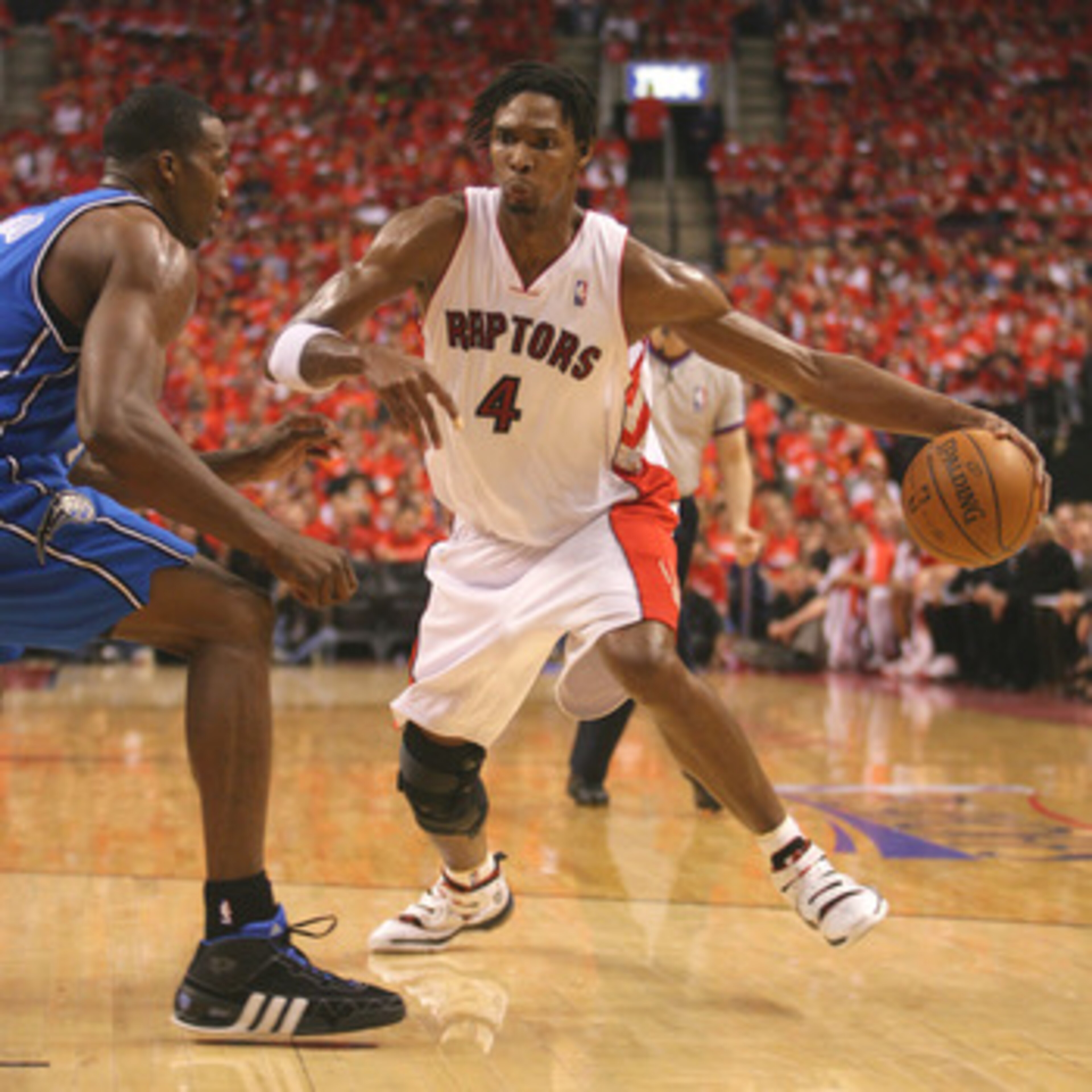 TORONTO,ON - APRIL 24: Chris Bosh #4 of the Toronto Raptors goes around Dwight Howard #12 of the Orlando Magic in game 3 of the Eastern Conference quarterfinals on April 24, 2008 at the Air Canada Centre in Toronto, Ontario. (Photo by Claus Andersen/Getty TORONTO,ON - APRIL 24: Chris Bosh #4 of the Toronto Raptors goes around Dwight Howard #12 of the Orlando Magic in game 3 of the Eastern Conference quarterfinals on April 24, 2008 at the Air Canada Centre in Toronto, Ontario. (Photo by Claus Andersen/Getty