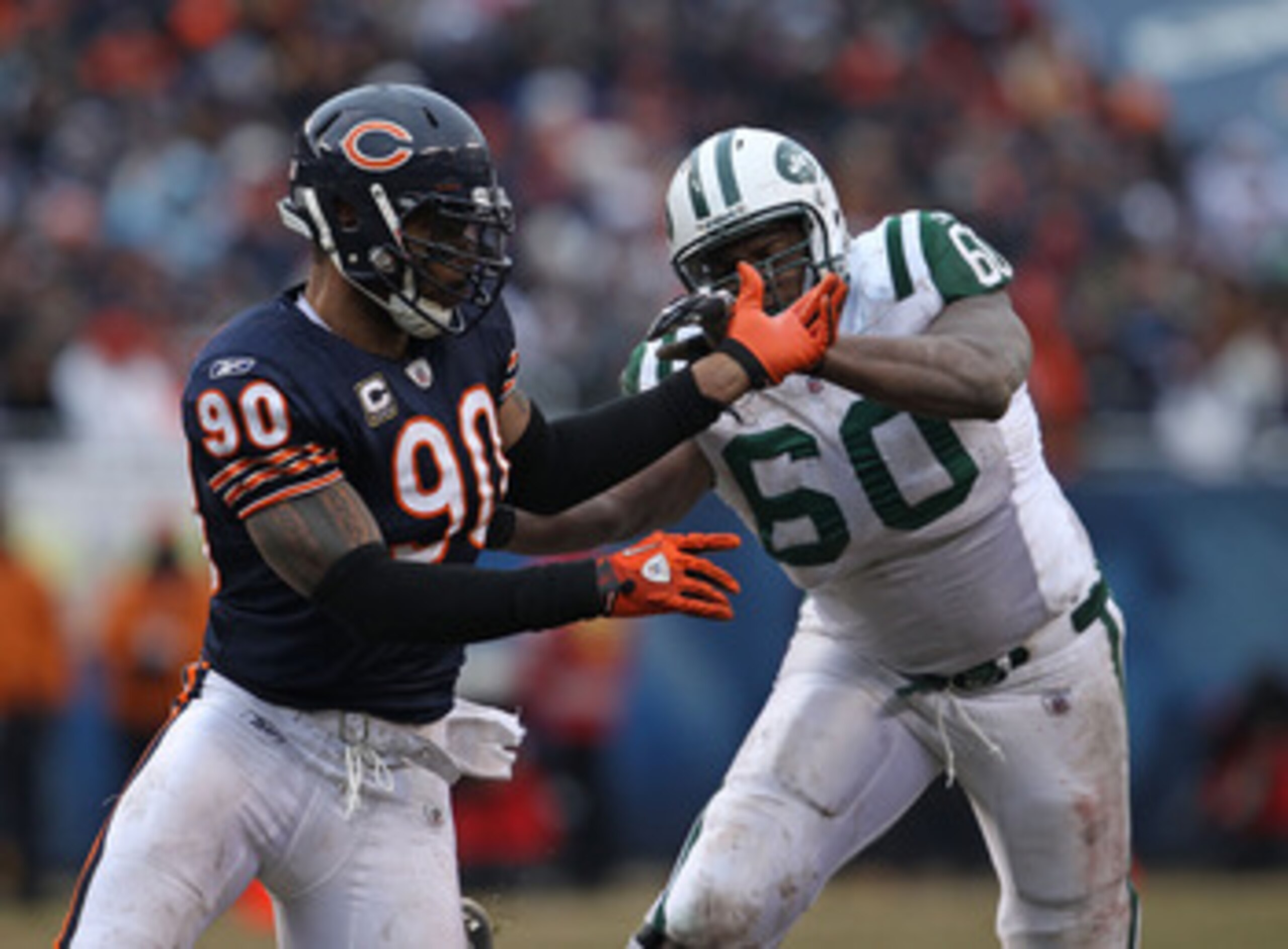 CHICAGO, IL - DECEMBER 26: Julius Peppers #90 of the Chicago Bears rushes against D' Brickashaw Ferguson #60 of the New York Jets at Soldier Field on December 26, 2010 in Chicago, Illinois. The Bears defeated the Jets 38-34. (Photo by Jonathan Daniel/Gett