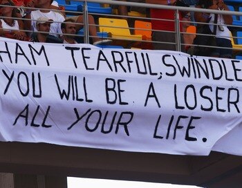 ISTANBUL, TURKEY - AUGUST 26:  Fans of Fernando Alonso of Spain and McLaren Mercedes hold a sign saying 'Ham Tearful, swindler you will be a loser all your life' aimed at Lewis Hamilton of Great Britain and McLaren Mercedes during the F1 Grand Prix of Tur