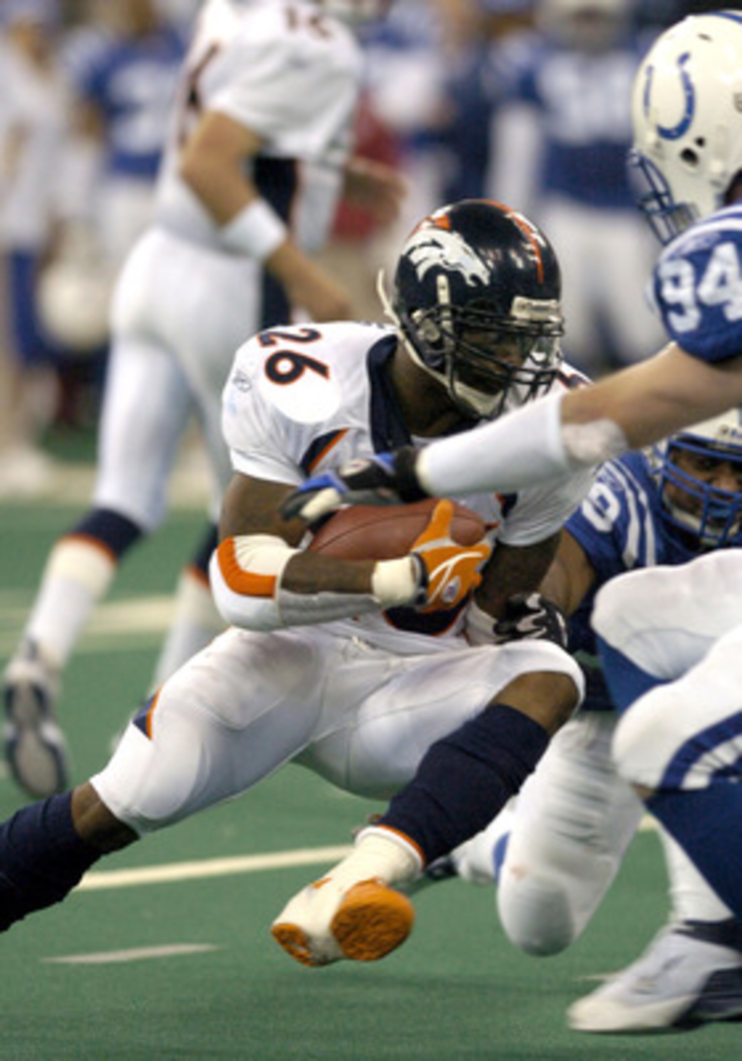 Denver Broncos running back Clinton Portis rushes for a gain at the RCA Dome, Indianapolis, Indiana, January 4, 2004 in an AFC wildcard playoff game.  (Photo by Al Messerschmidt/Getty Images)