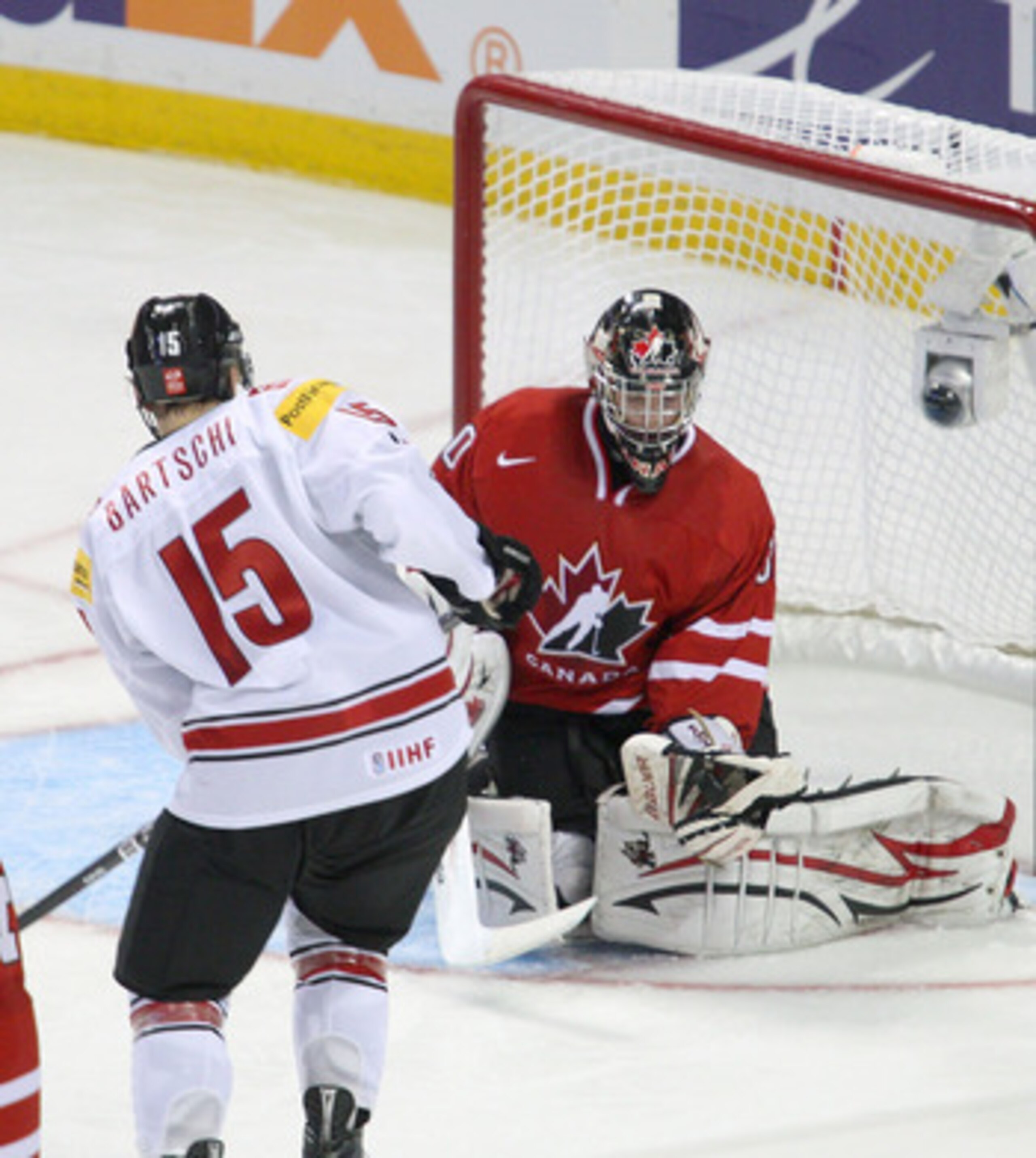 BUFFALO, NY - JANUARY 02: Mark Visentin #30 of Canada makes a save on Sven Bartschi #15 of Switzerland during the 2011 IIHF World U20 Championship game between Canada and Switzerland on January 2, 2011 in Buffalo, New York. Canada won 4-1. (Photo by Rick