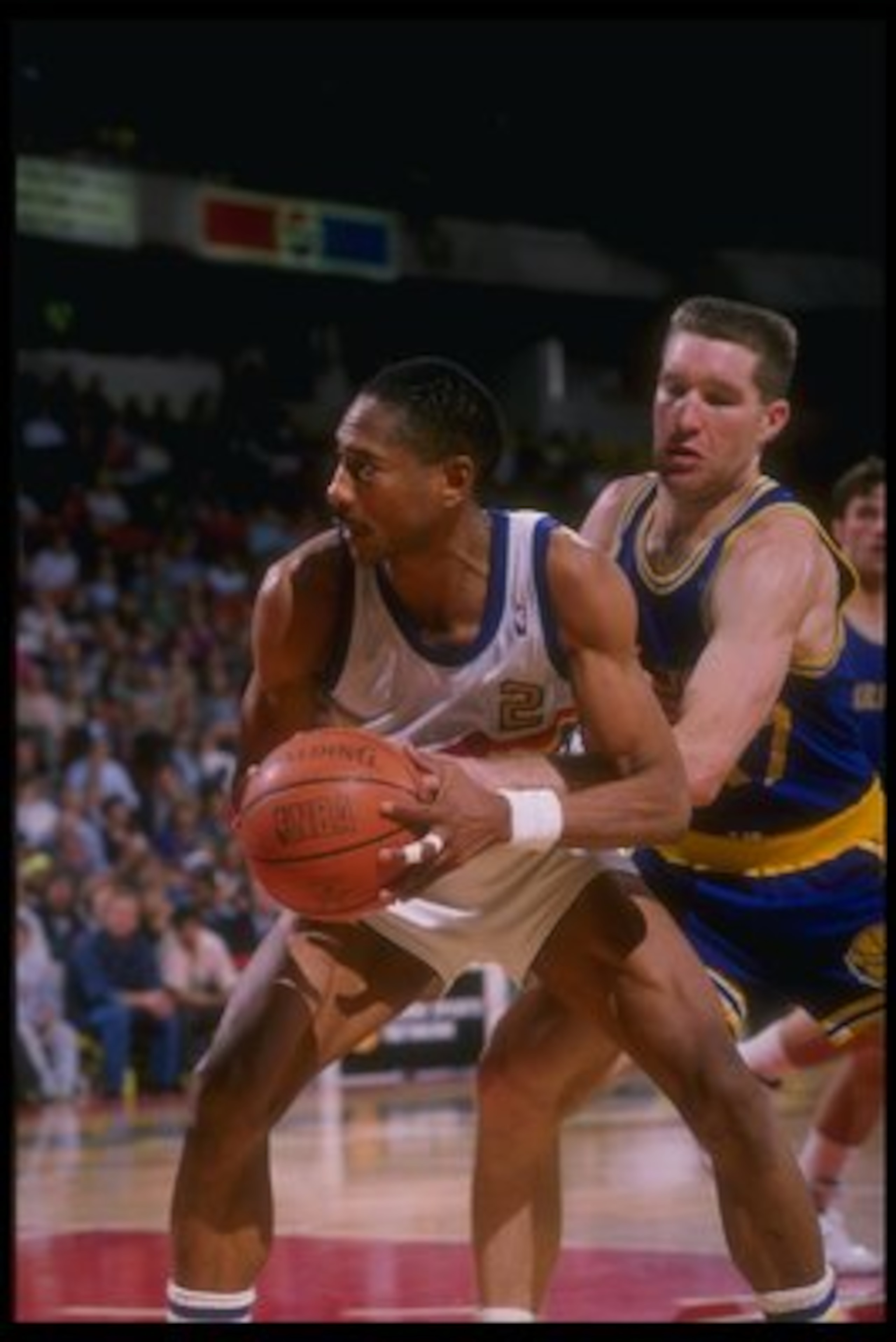 1989-1990:  Guard Alex English #2 of the Denver Nuggets screens forward Chris Mullin of the Golden State Warriors from the ball during a game at the McNichols Sports Arena in Denver, Colorado. Mandatory Credit: Tim DeFrisco  /Allsport Mandatory Credit: Ti