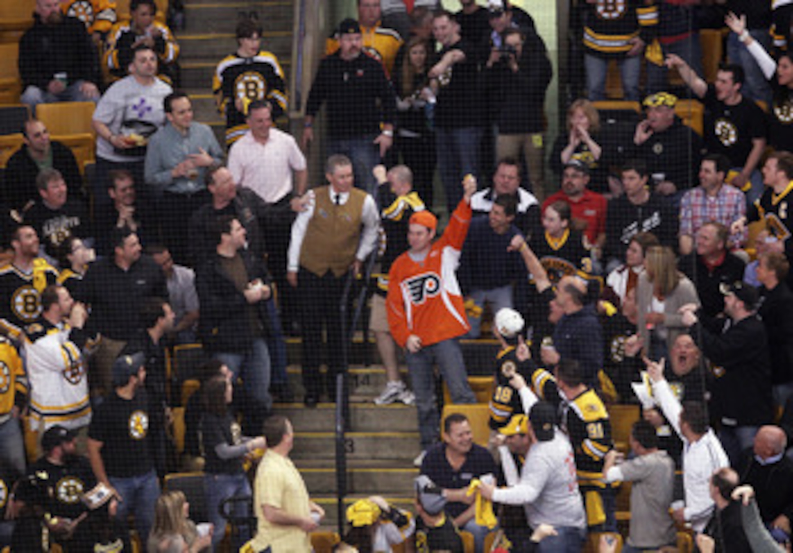 BOSTON, MA - MAY 06: A Philadelphia Flyers fan catches an errant puck amidst the Boston Bruins fans in Game Four of the Eastern Conference Semifinals during the 2011 NHL Stanley Cup Playoffs at TD Garden on May 6, 2011 in Boston, Massachusetts. The Bruins