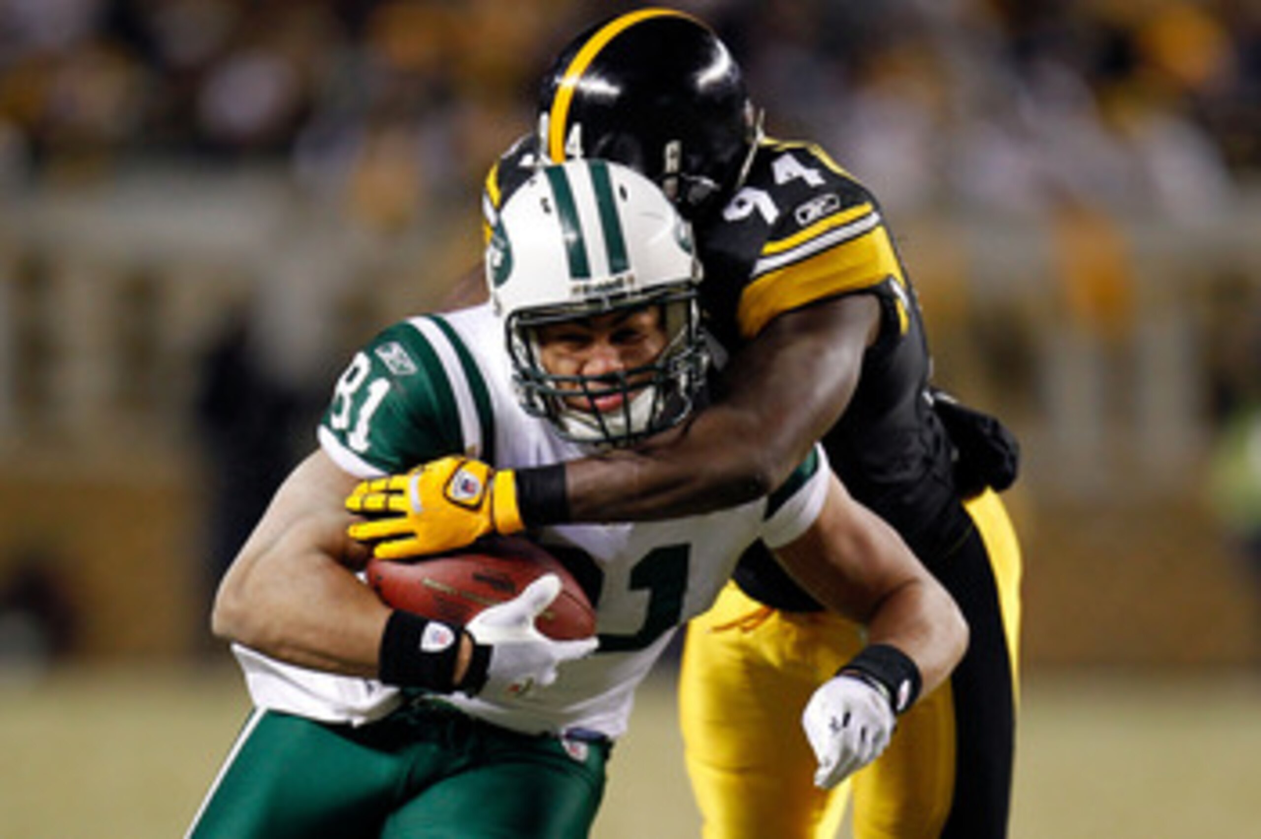 PITTSBURGH, PA - JANUARY 23:  Dustin Keller #81 of the New York Jets tries to avoid the tackle of Lawrence Timmons #94 of the Pittsburgh Steelers during the 2011 AFC Championship game at Heinz Field on January 23, 2011 in Pittsburgh, Pennsylvania.  (Photo