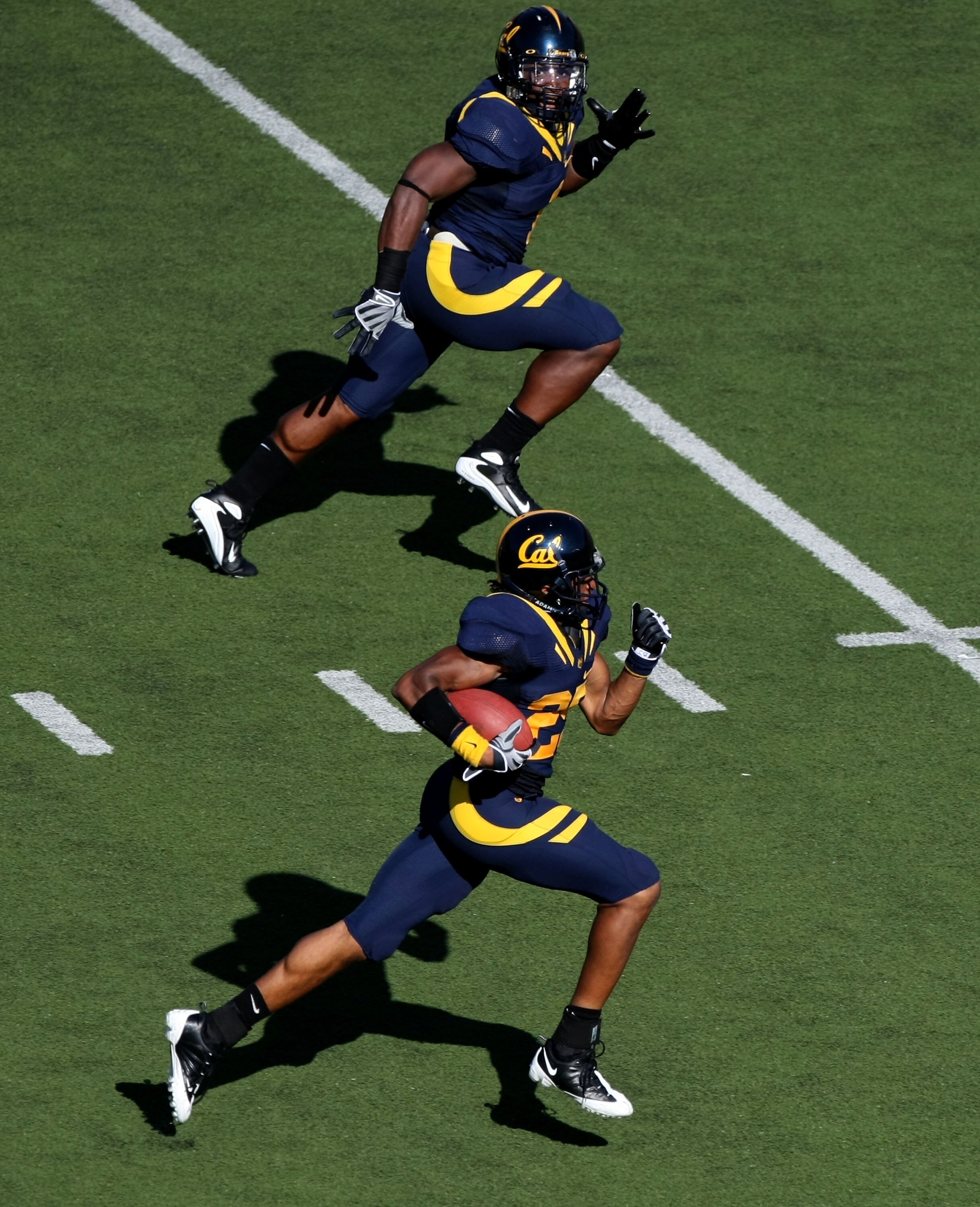 BERKELEY, CA - SEPTEMBER 27:  Brett Johnson #25 of the California Golden Bears returns an interception with for a touchdown with teammate Mychal Kendricks #30 against the Colorado State Rams during an NCAA football game on September 27, 2008 at Memorial S