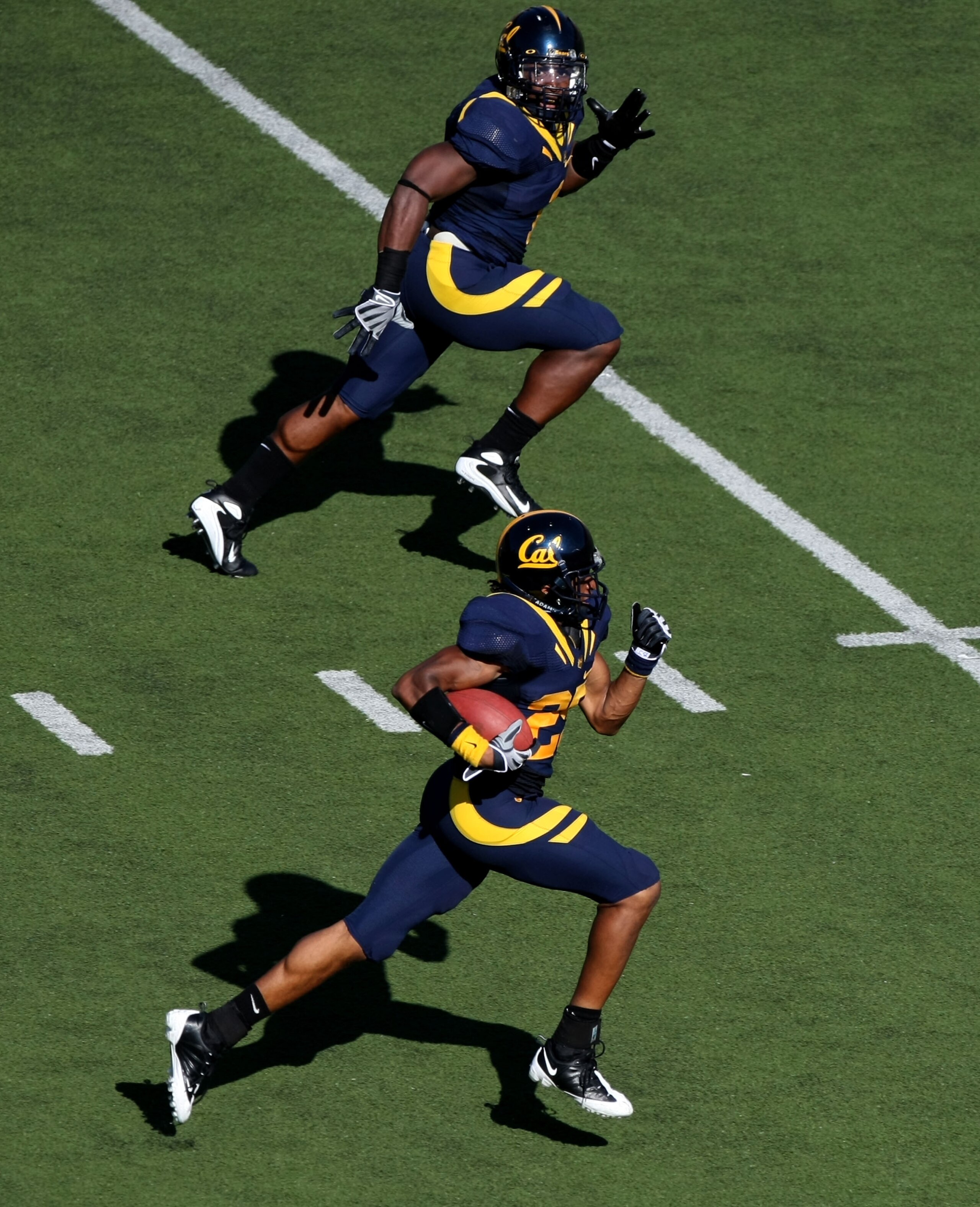 BERKELEY, CA - SEPTEMBER 27:  Brett Johnson #25 of the California Golden Bears returns an interception with for a touchdown with teammate Mychal Kendricks #30 against the Colorado State Rams during an NCAA football game on September 27, 2008 at Memorial S