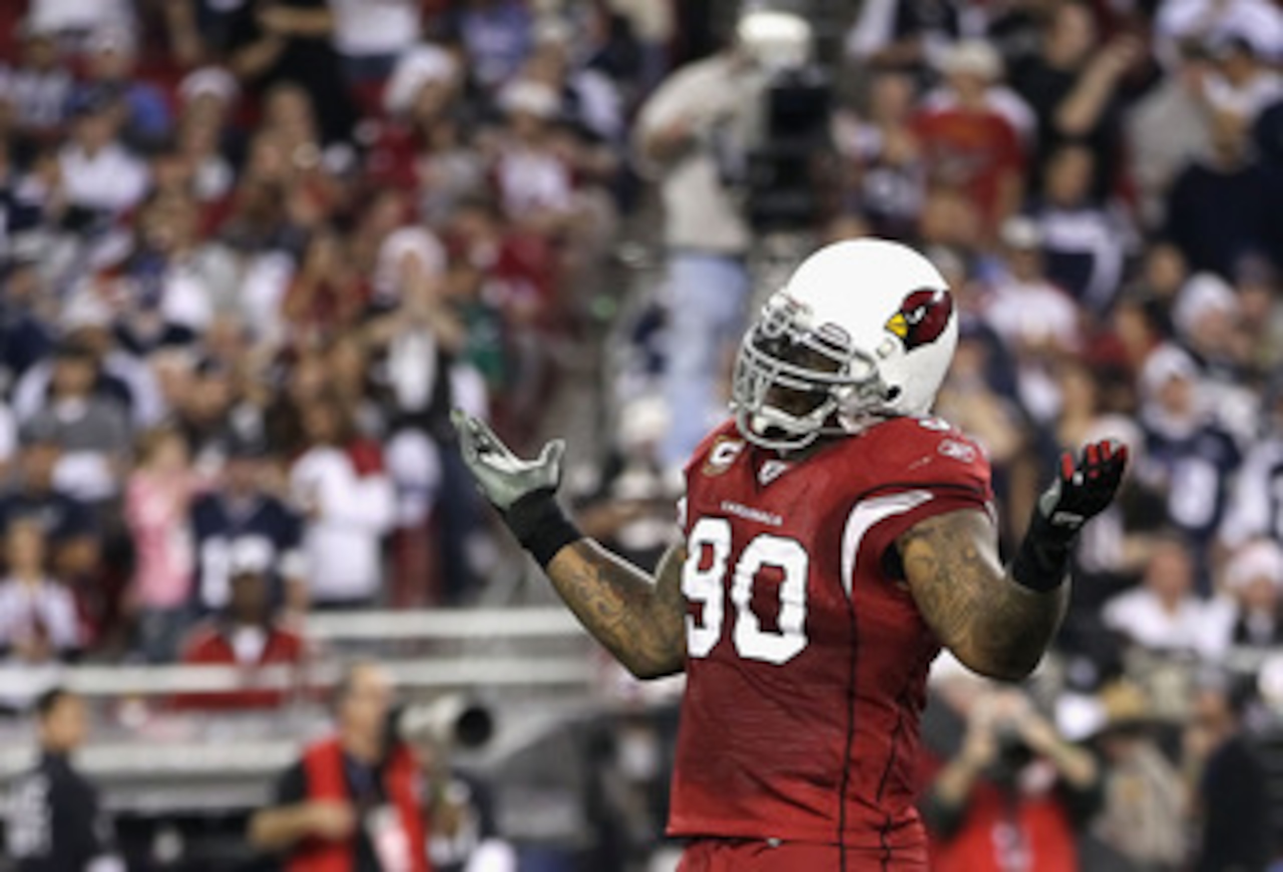 GLENDALE, AZ - DECEMBER 25:  Defensive tackle Darnell Dockett #90 of the Arizona Cardinals reacts after sacking quarterback Jon Kitna of the Dallas Cowboys (not picutred) during the second quarter of the NFL game at the University of Phoenix Stadium on De