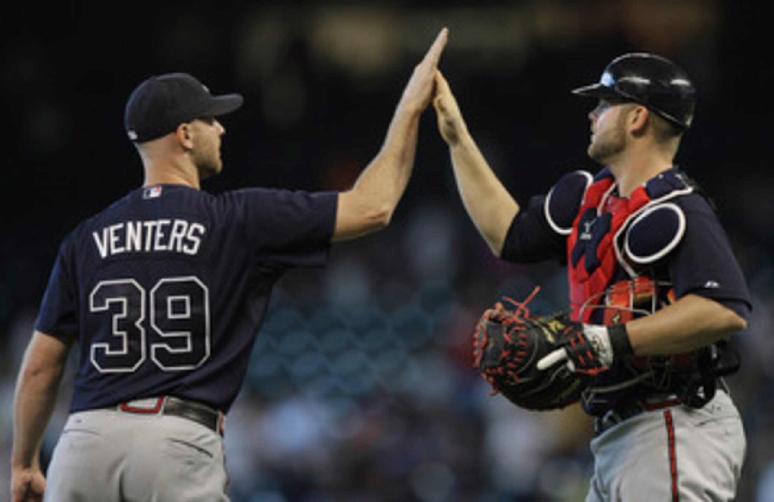 HOUSTON - JUNE 12:  Pitcher Jonny Venters #39 of the Atlanta Braves high fives catcher Brian McCann #16 after the final out against the Houston Astros at Minute Maid Park on June 12, 2011 in Houston, Texas.  (Photo by Bob Levey/Getty Images)