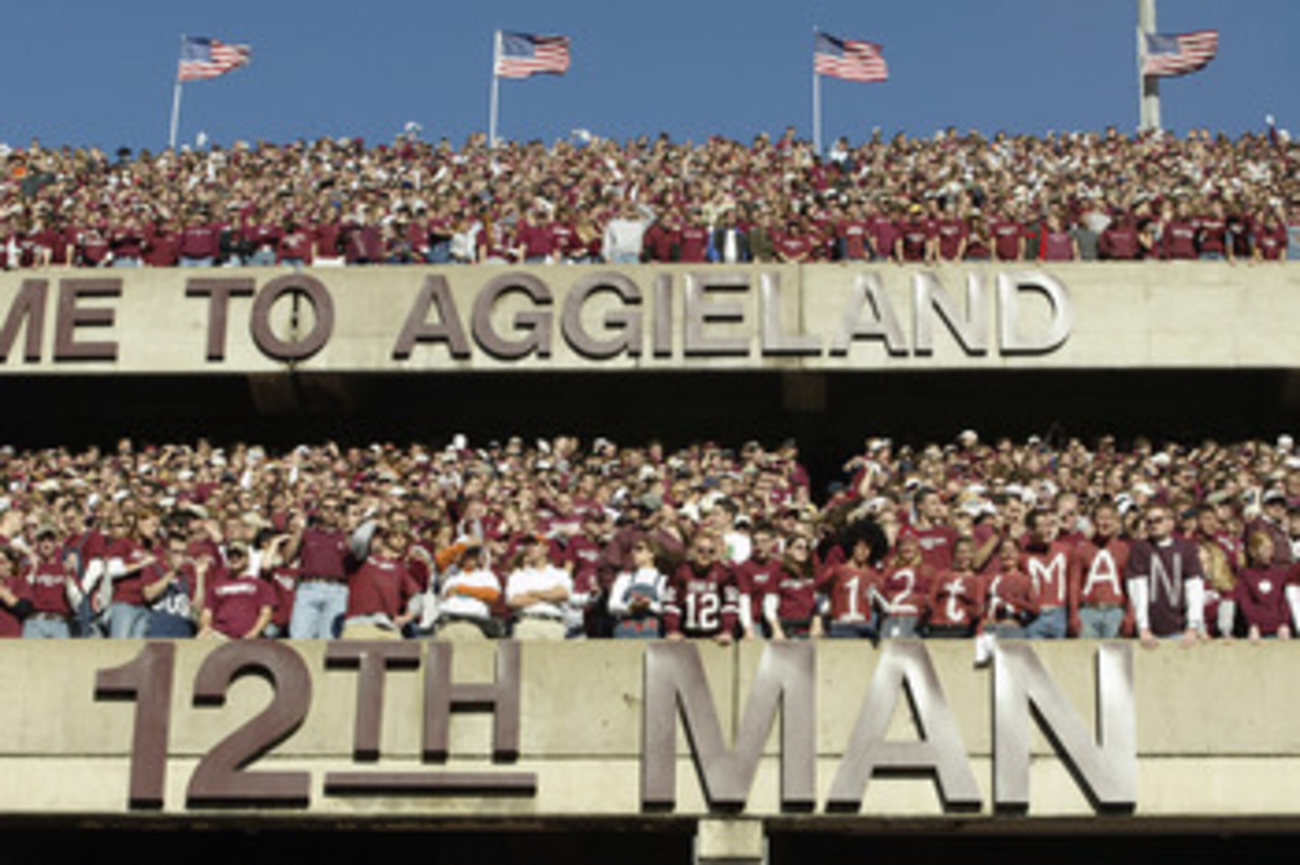 COLLEGE STATION, TX - NOVEMBER 28:  Texas A&M University Aggies fans, sometimes referred to as the 12th Man, stand during the game against the University of Texas at Austin Longhorns, at Kyle Field on November 28, 2003 in College Station, Texas.  The Texa