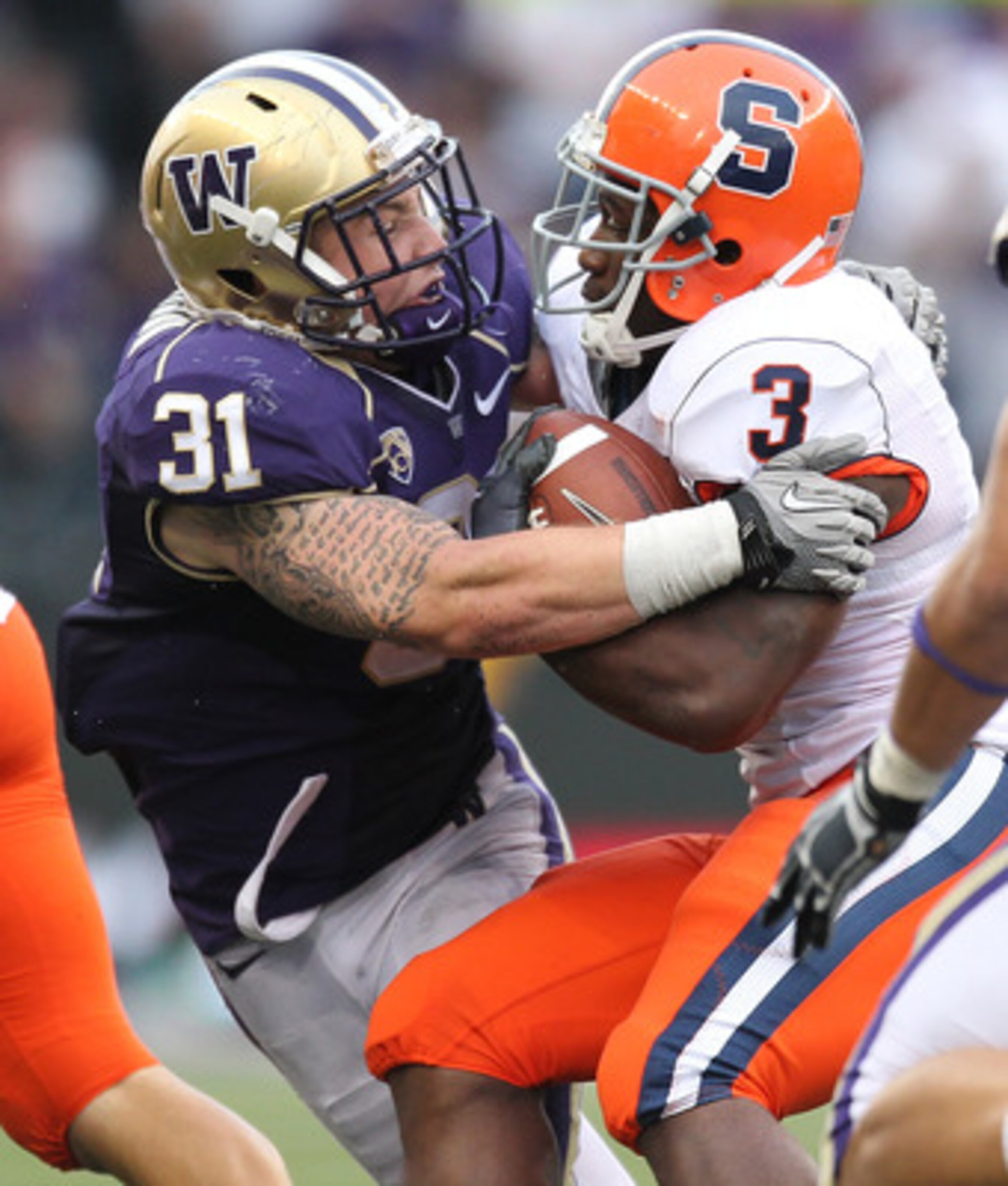 SEATTLE - SEPTEMBER 11:  Running back Delone Carter #3 of the Syracuse Orange rushes against Cort Dennison #31 of the Washington Huskies on September 11, 2010 at Husky Stadium in Seattle, Washington. The Huskies defeated the Orange 41-20. (Photo by Otto G