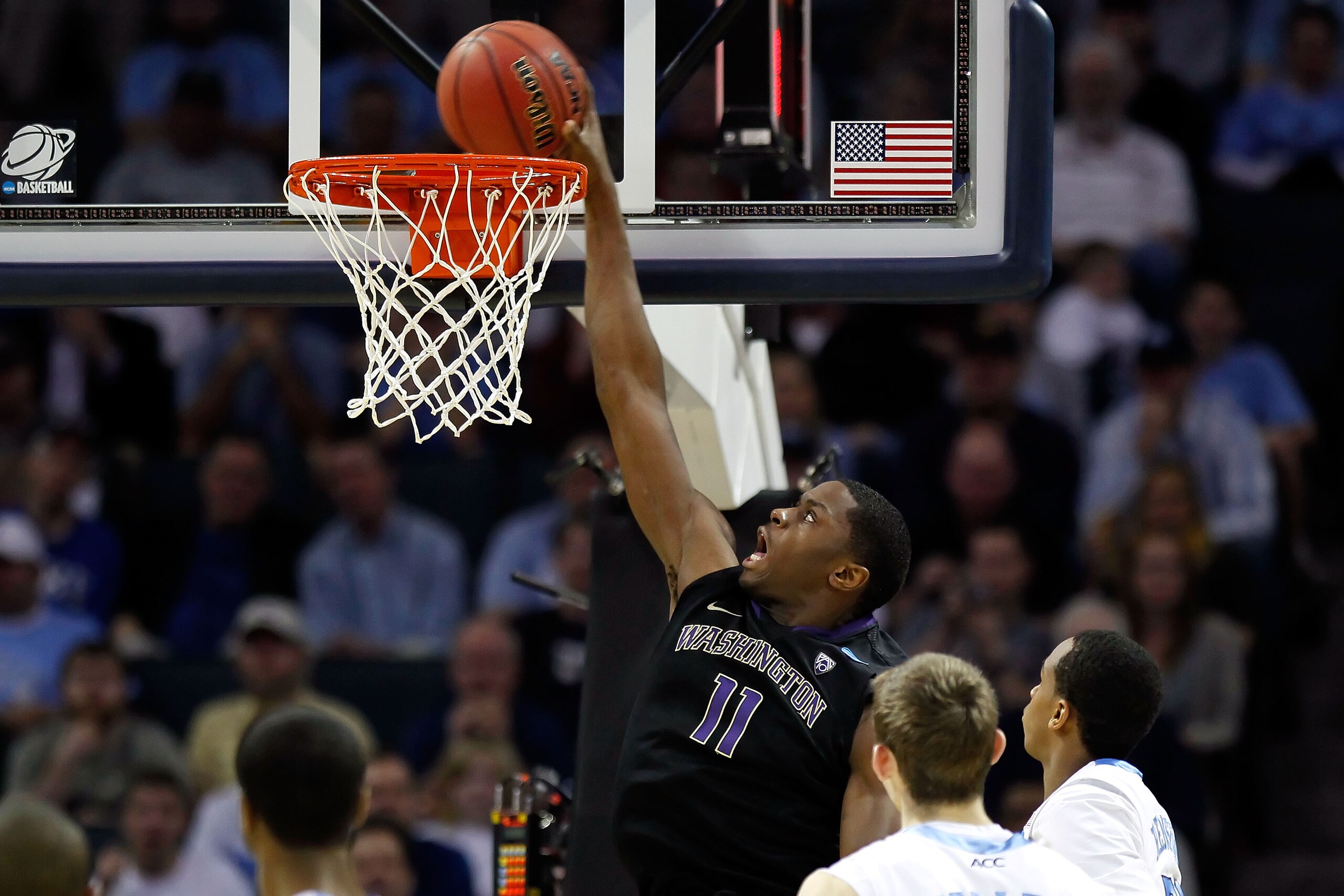 CHARLOTTE, NC - MARCH 20:  Matthew Bryan-Amaning #11 of the Washington Huskies dunks the ball in the second half while taking on the North Carolina Tar Heels during the third round of the 2011 NCAA men's basketball tournament at Time Warner Cable Arena on