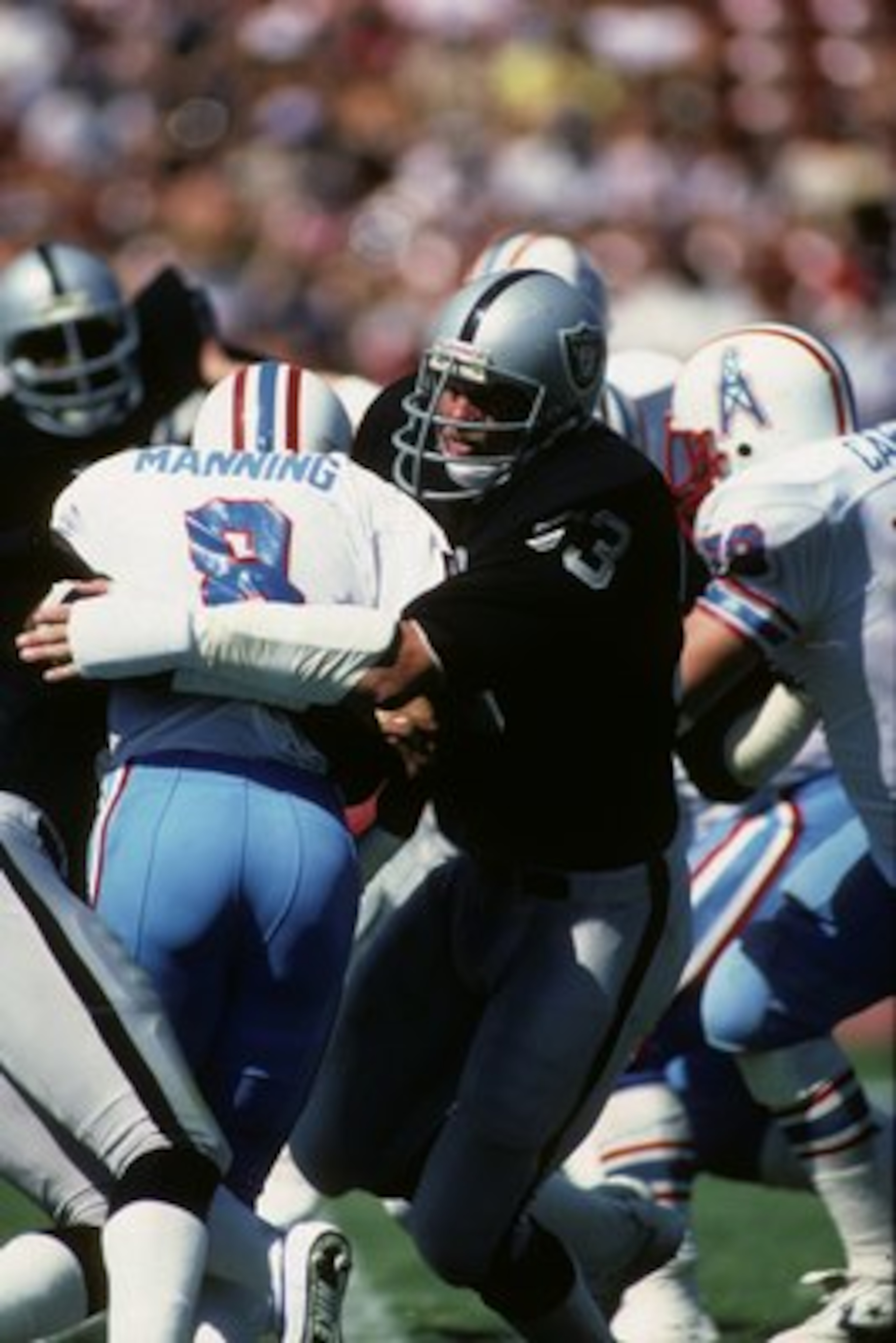 LOS ANGELES - SEPTEMBER 11:  Linebacker Ted Hendricks #83 of the Los Angeles Raiders tackles Houston Oilers quarterback Archie Manning #8 during the game at the Los Angeles Memorial Coliseum on September 11, 1983 in Los Angeles, California.  The Raiders w