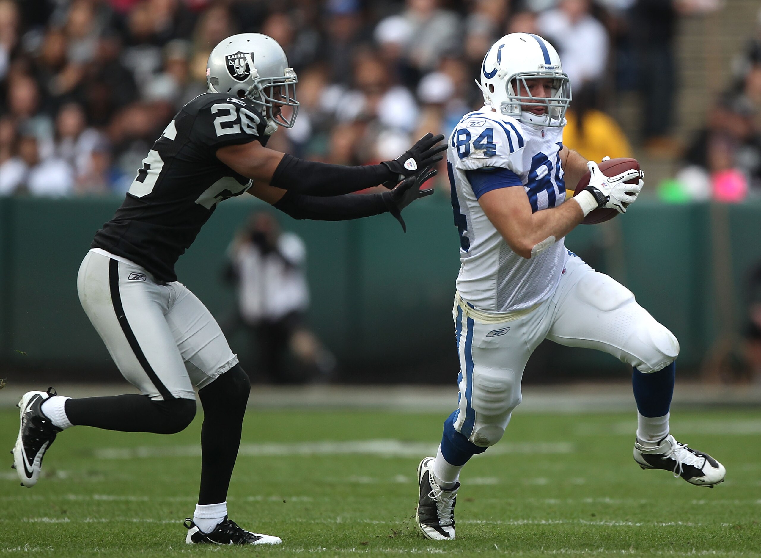 OAKLAND, CA - DECEMBER 26:  Jacob Tamme #84 of the Indianapolis Colts runs after a catch past Stanford Routt #26 of the Oakland Raiders during an NFL game at Oakland-Alameda County Coliseum on December  26, 2010 in Oakland, California.  (Photo by Jed Jaco