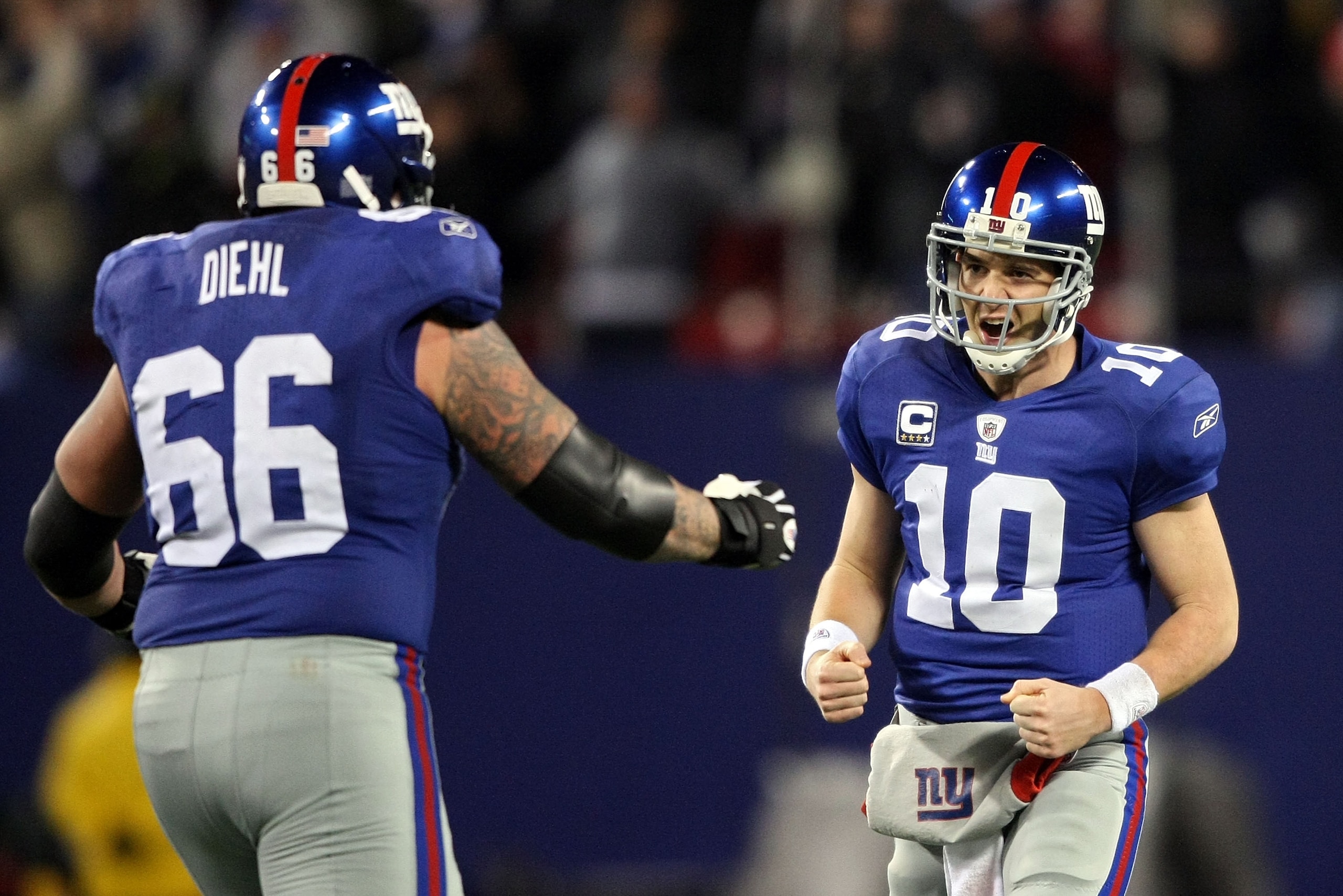 EAST RUTHERFORD, NJ - DECEMBER 13:  Eli Manning #10 of the New York Giants celebrates with David Diehl #66 after a touchdown pass in the third quarter against the Philadelphia Eagles at Giants Stadium on December 13, 2009 in East Rutherford, New Jersey.
