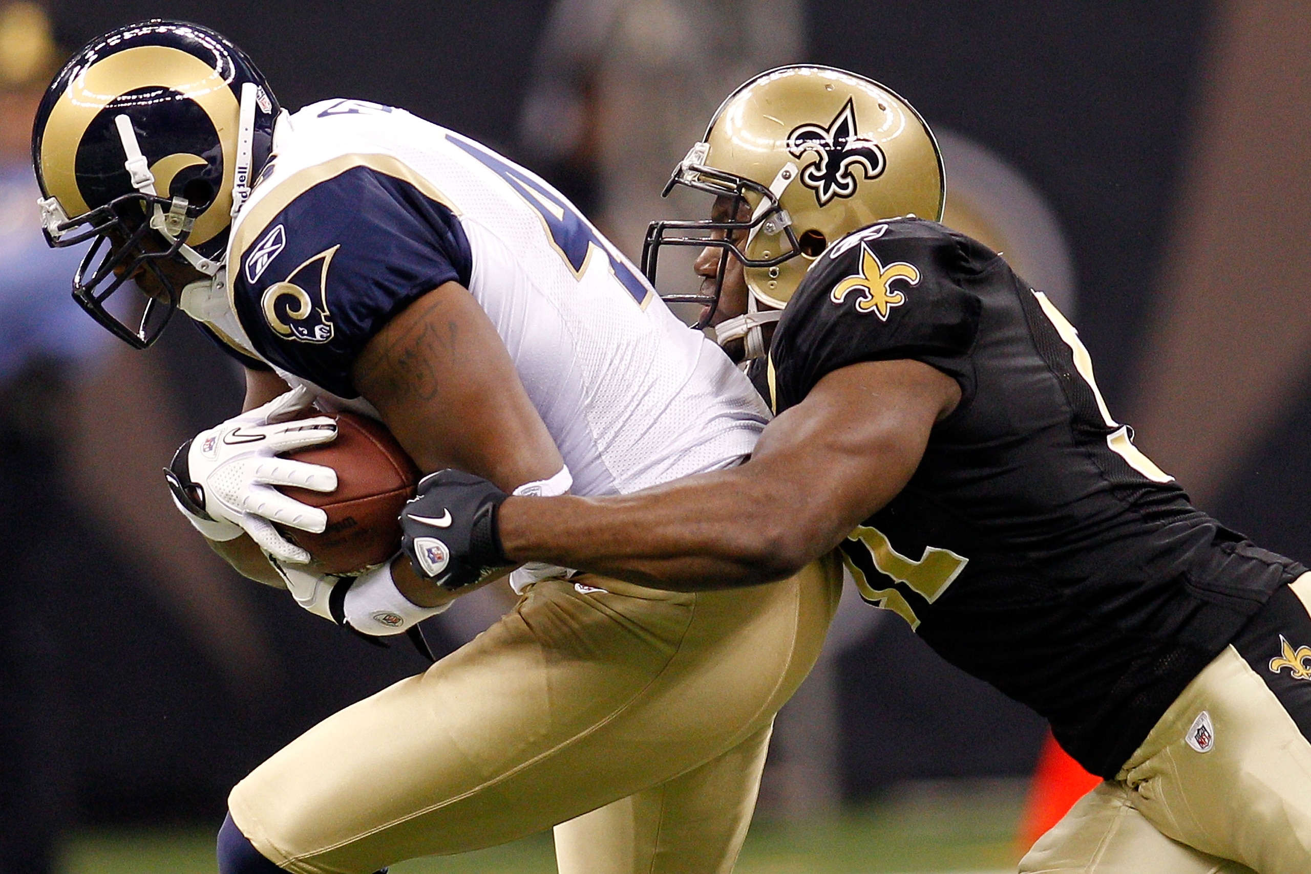 NEW ORLEANS, LA - DECEMBER 12:  Daniel Fells #46 of the St. Louis Rams is tackled by Jonathan Vilma#51 of the New Orleans Saints at the Louisiana Superdome on December 12, 2010 in New Orleans, Louisiana.  (Photo by Chris Graythen/Getty Images)
