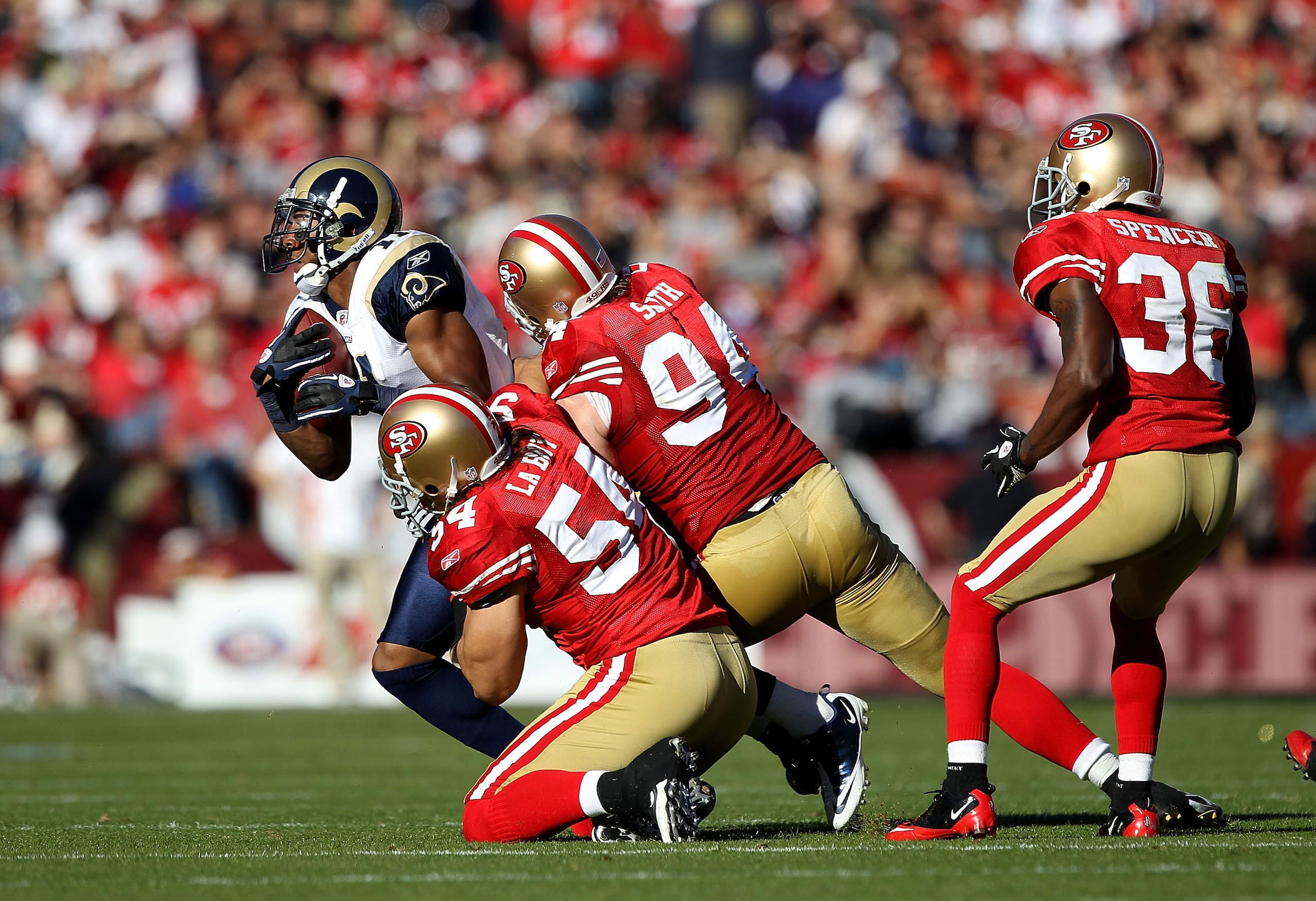 SAN FRANCISCO - NOVEMBER 14:  Brandon Gibson #11 of the St. Louis Rams is tackled by Travis LaBoy #54 and Justin Smith #94 of the San Francisco 49ers at Candlestick Park on November 14, 2010 in San Francisco, California.  (Photo by Ezra Shaw/Getty Images)