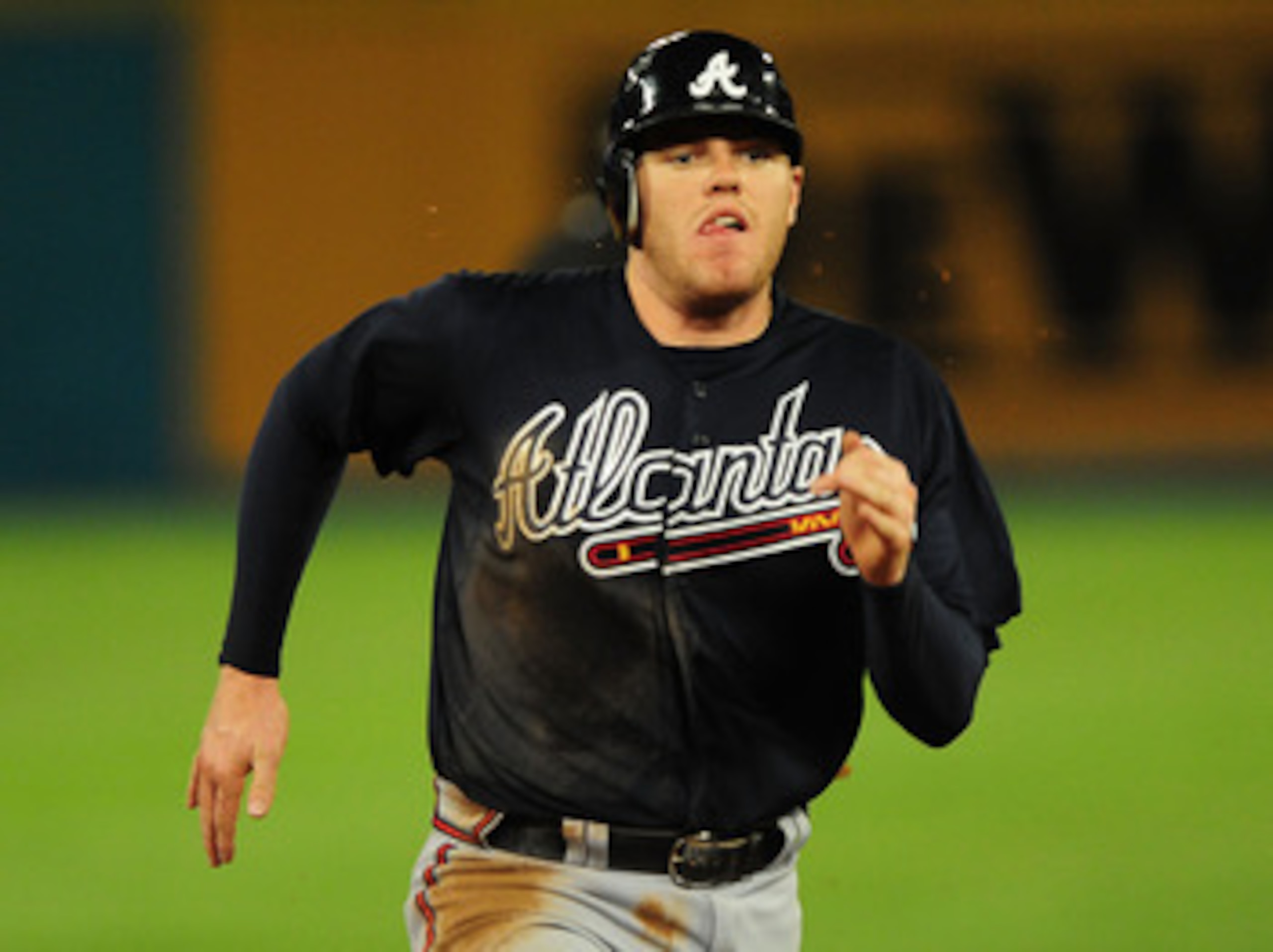 MIAMI GARDENS, FL - JUNE 09:  Freddie Freeman #5 of the Atlanta Braves rounds second base after hitting a triple against the Florida Marlins at Sun Life Stadium on June 9, 2011 in Miami Gardens, Florida.  (Photo by Marc Serota/Getty Images)