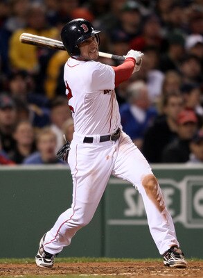 BOSTON, MA - MAY 22:  Jed Lowrie #12 of the Boston Red Sox hits an RBI single in the fourth inning against the Chicago Cubs on May 22, 2011 at Fenway Park in Boston, Massachusetts.  Before this series, the two teams haven't played at Fenway Park since the
