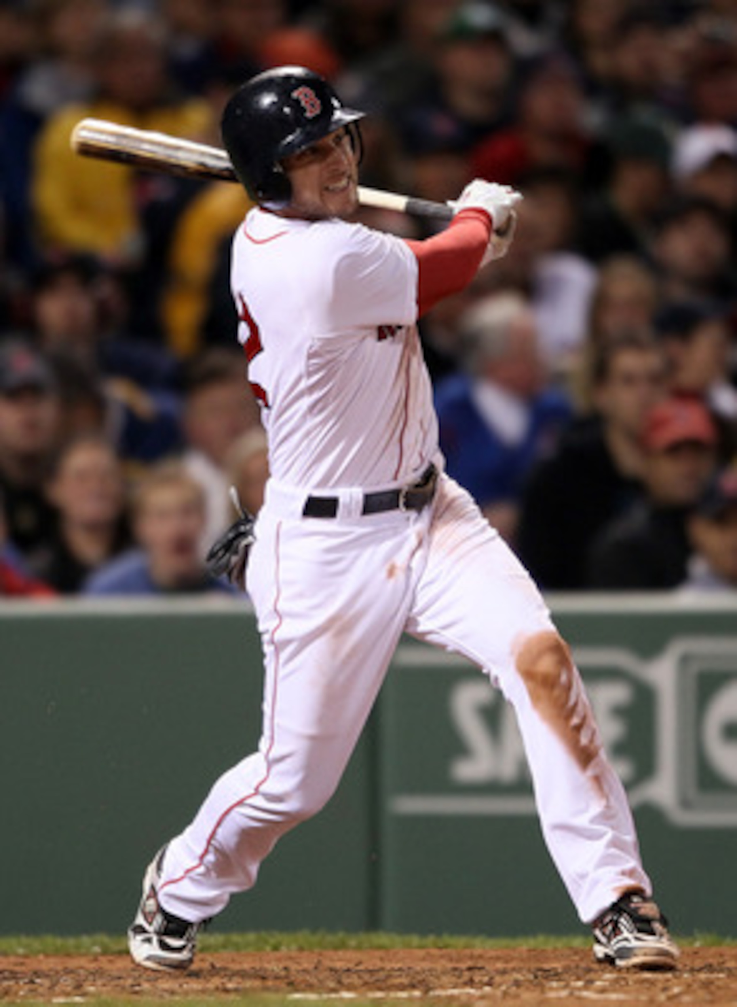 BOSTON, MA - MAY 22:  Jed Lowrie #12 of the Boston Red Sox hits an RBI single in the fourth inning against the Chicago Cubs on May 22, 2011 at Fenway Park in Boston, Massachusetts.  Before this series, the two teams haven't played at Fenway Park since the