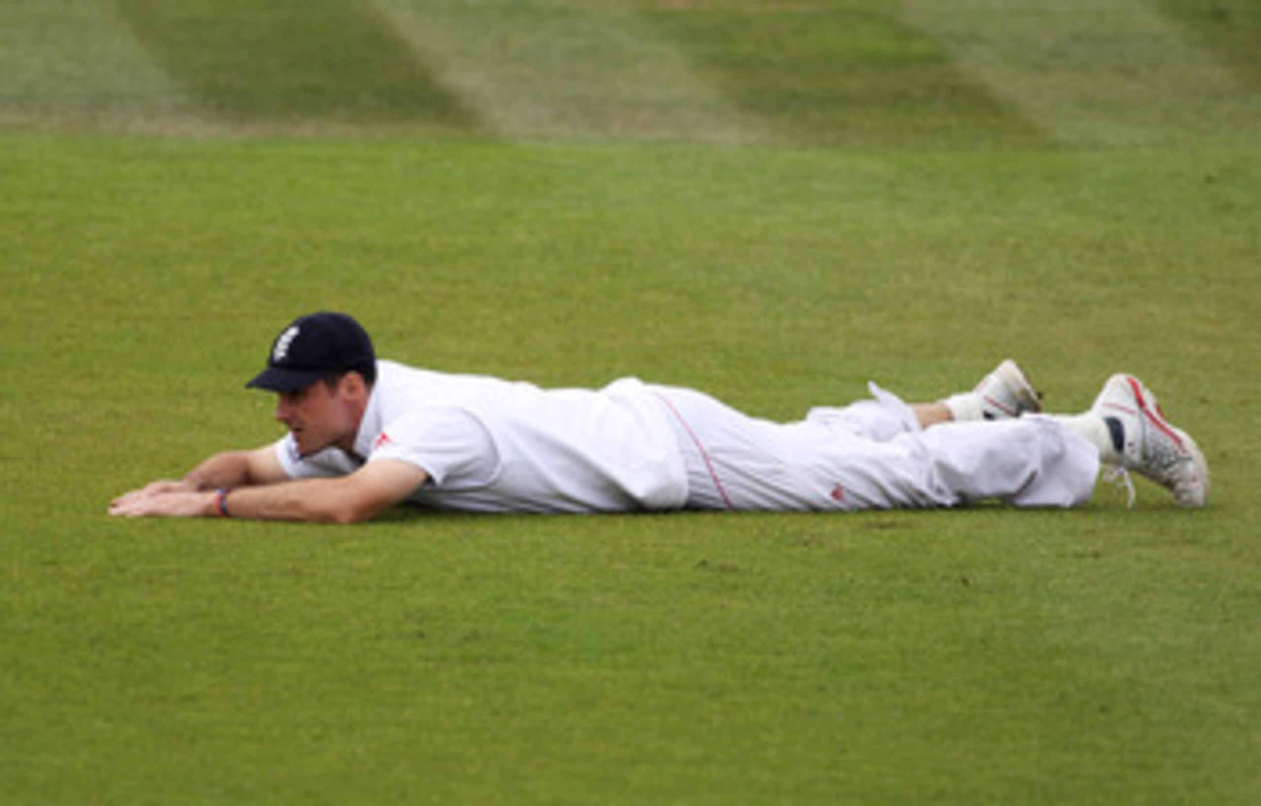 SOUTHAMPTON, ENGLAND - JUNE 20: Andrew Strauss of England lies on the ground as the ball rolls to the boundary during day five of the 3rd npower Test Match between England and Sri Lanka at the Rose Bowl on June 20, 2011 in Southampton, England.  (Photo by