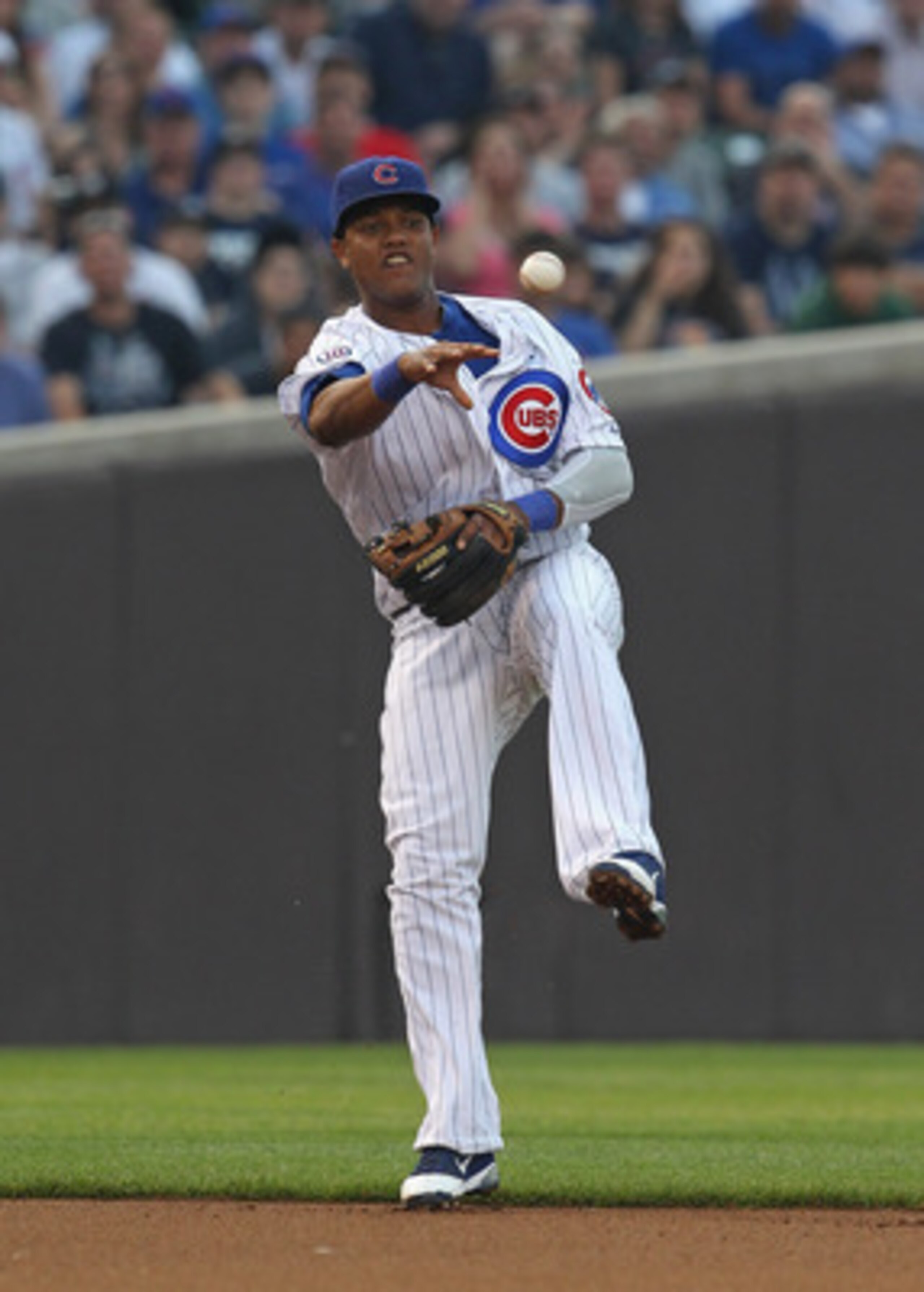 CHICAGO, IL - JUNE 19: Starlin Castro #13 of the Chicago Cubs leaps to make a throw to 2nd base against the New York Yankees at Wrigley Field on June 19, 2011 in Chicago, Illinois. The Yankees defeated Cubs 10-4. (Photo by Jonathan Daniel/Getty Images)