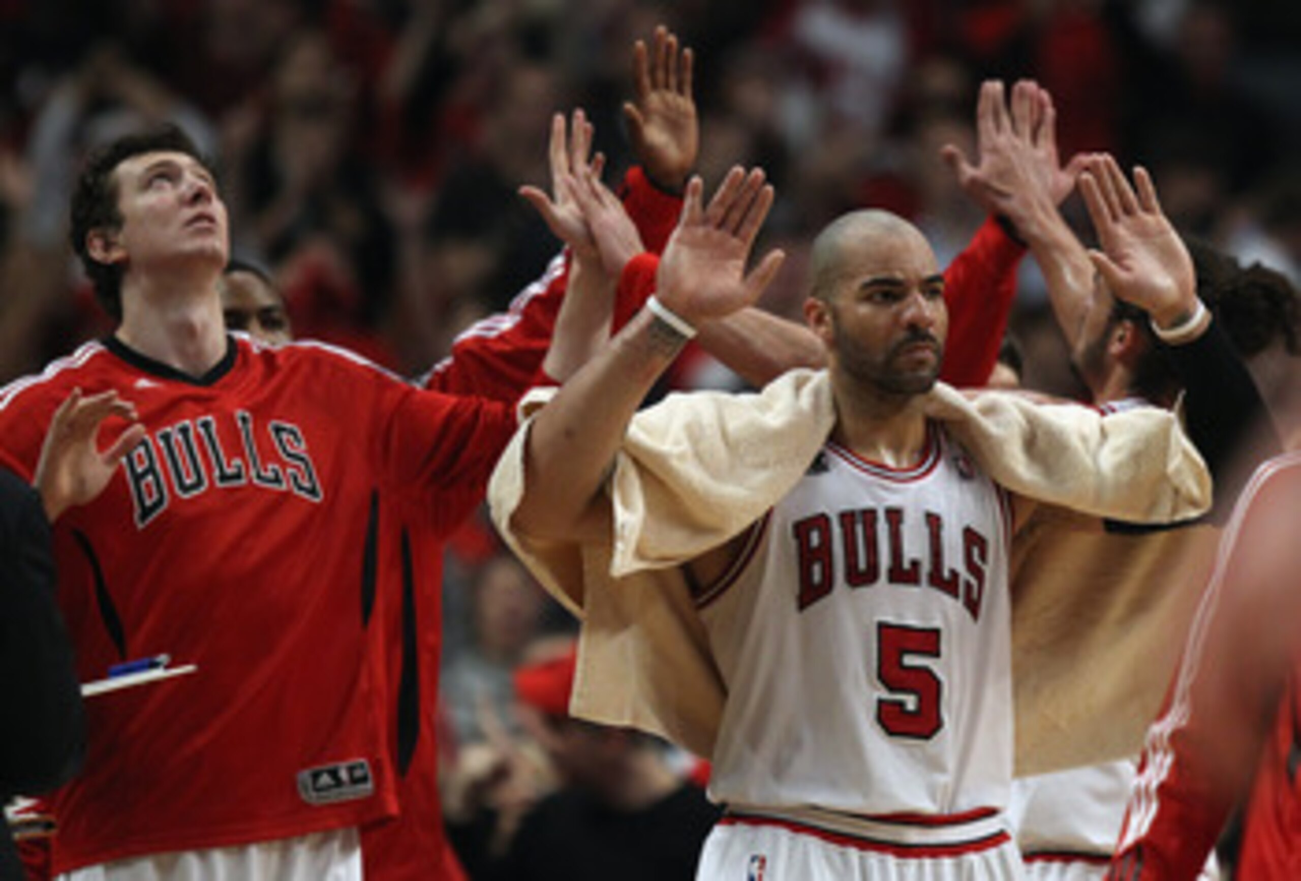 CHICAGO, IL - APRIL 16: Omer Asik #3 and Carlos Boozer #5 of the Chicago Bulls join teammates in welcoming players to the bench during a time-out against the Indiana Pacers in Game One of the Eastern Conference Quarterfinals in the 2011 NBA Playoffs at th CHICAGO, IL - APRIL 16: Omer Asik #3 and Carlos Boozer #5 of the Chicago Bulls join teammates in welcoming players to the bench during a time-out against the Indiana Pacers in Game One of the Eastern Conference Quarterfinals in the 2011 NBA Playoffs at th