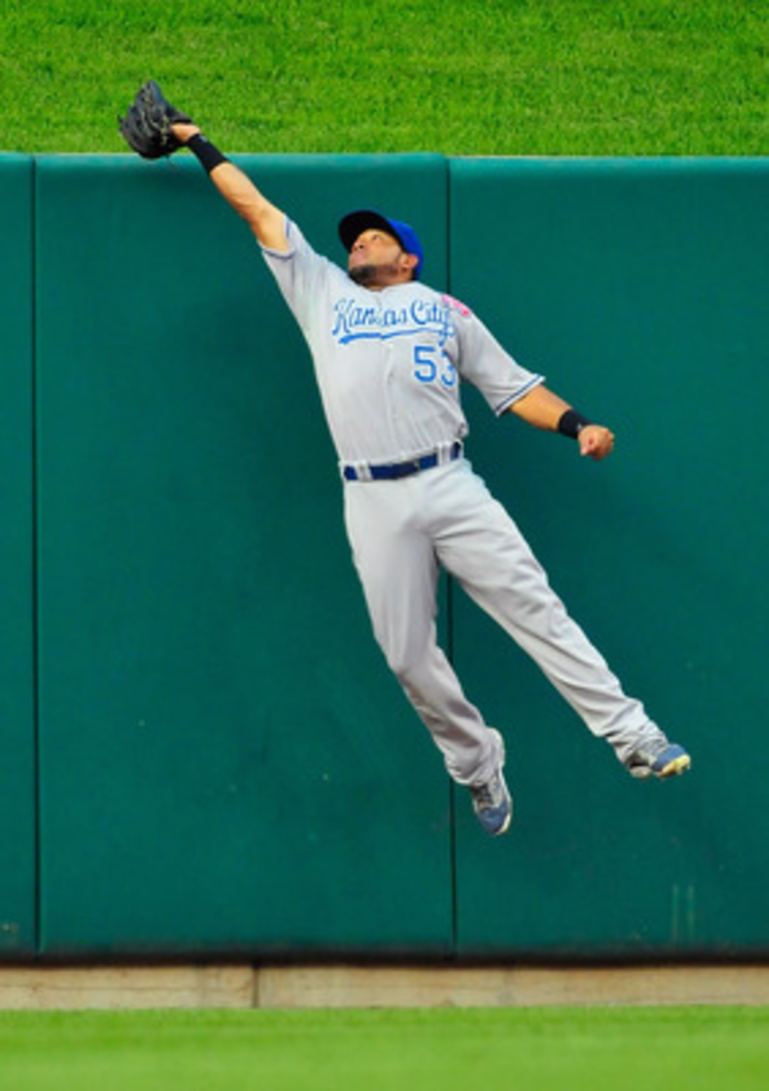 ST. LOUIS, MO - JUNE 18: Melky Cabrera #53 of the Kansas City Royals leap at the wall and catches a ball hit by Lance Berkman #12 of the St. Louis Cardinals at Busch Stadium on June 18, 2011 in St. Louis, Missouri.  (Photo by Jeff Curry/Getty Images)