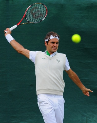 WIMBLEDON, ENGLAND - JUNE 19:  Roger Federer of Switzerland plays a shot during a training session ahead of the Wimbledon Lawn Tennis Championships on June 19, 2011 in Wimbledon, England.  (Photo by Michael Regan/Getty Images)