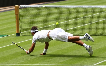 LONDON, ENGLAND - JUNE 20:  Rafael Nadal of Spain reaches for a shot during his first round match against Michael Russell of the United States on Day One of the Wimbledon Lawn Tennis Championships at the All England Lawn Tennis and Croquet Club on June 20